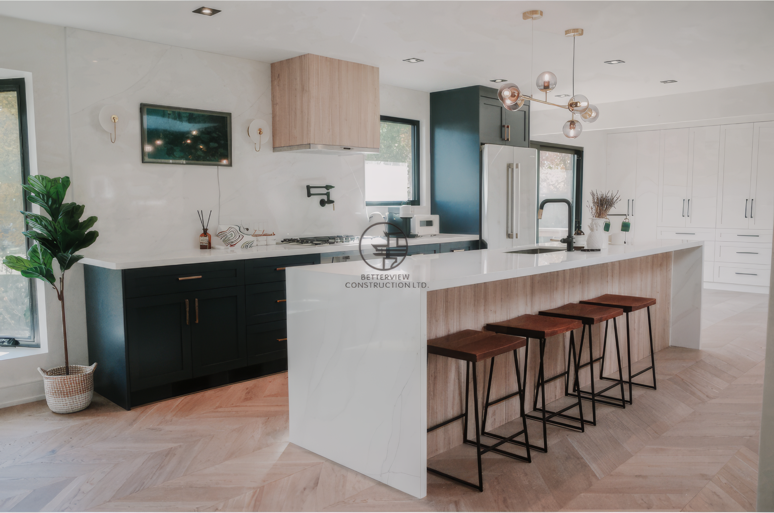 Modern kitchen renovation with large waterfall island, bar stools, custom cabinetry, and herringbone hardwood flooring.