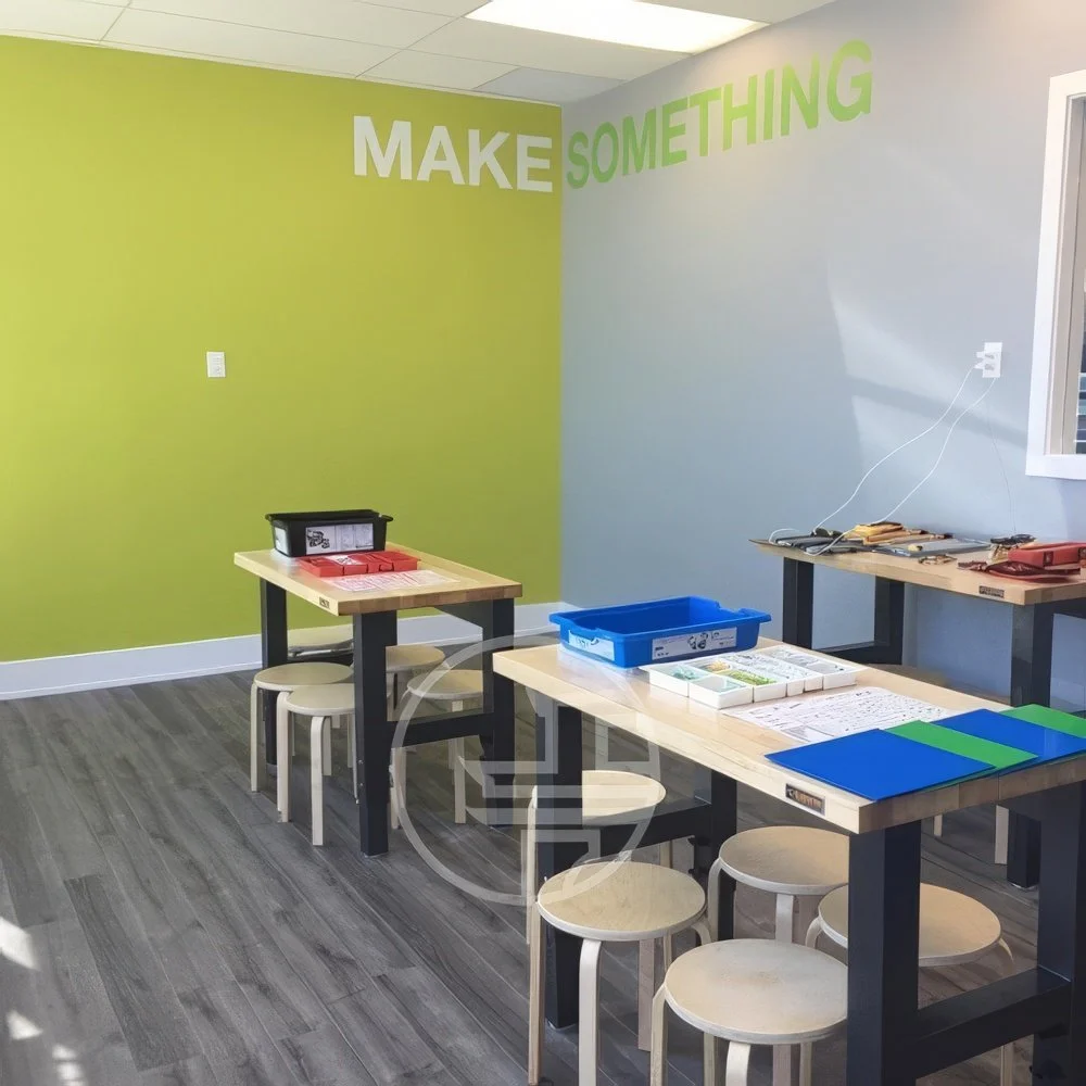 Creative classroom renovation in Toronto featuring collaborative learning tables, modern interior design, and branded education space