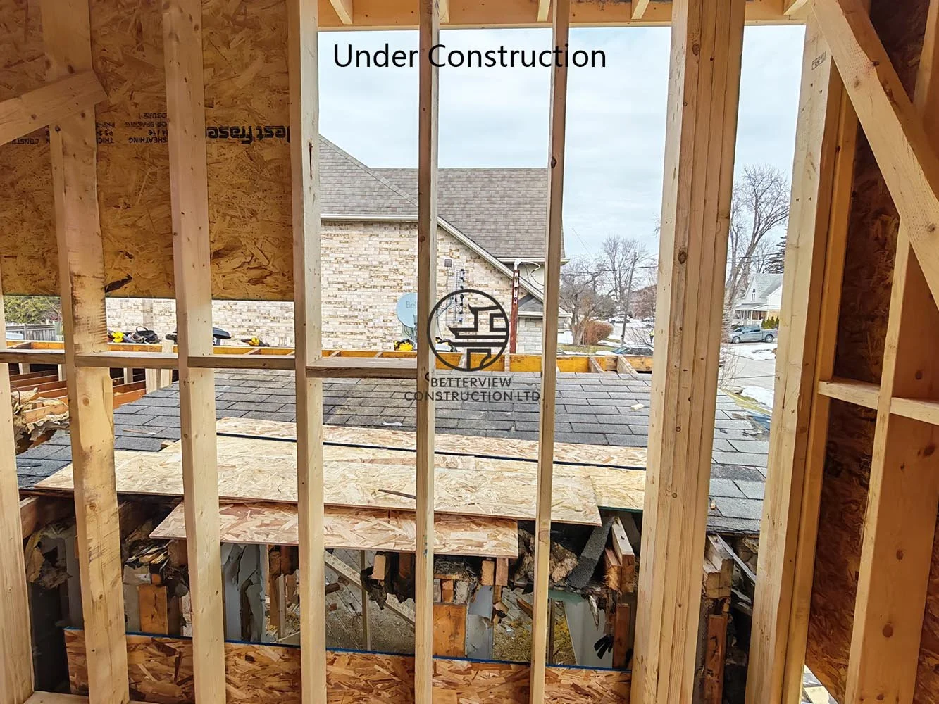 Interior wall framing for a residential home addition with large window openings, maximizing natural light and modern living design.