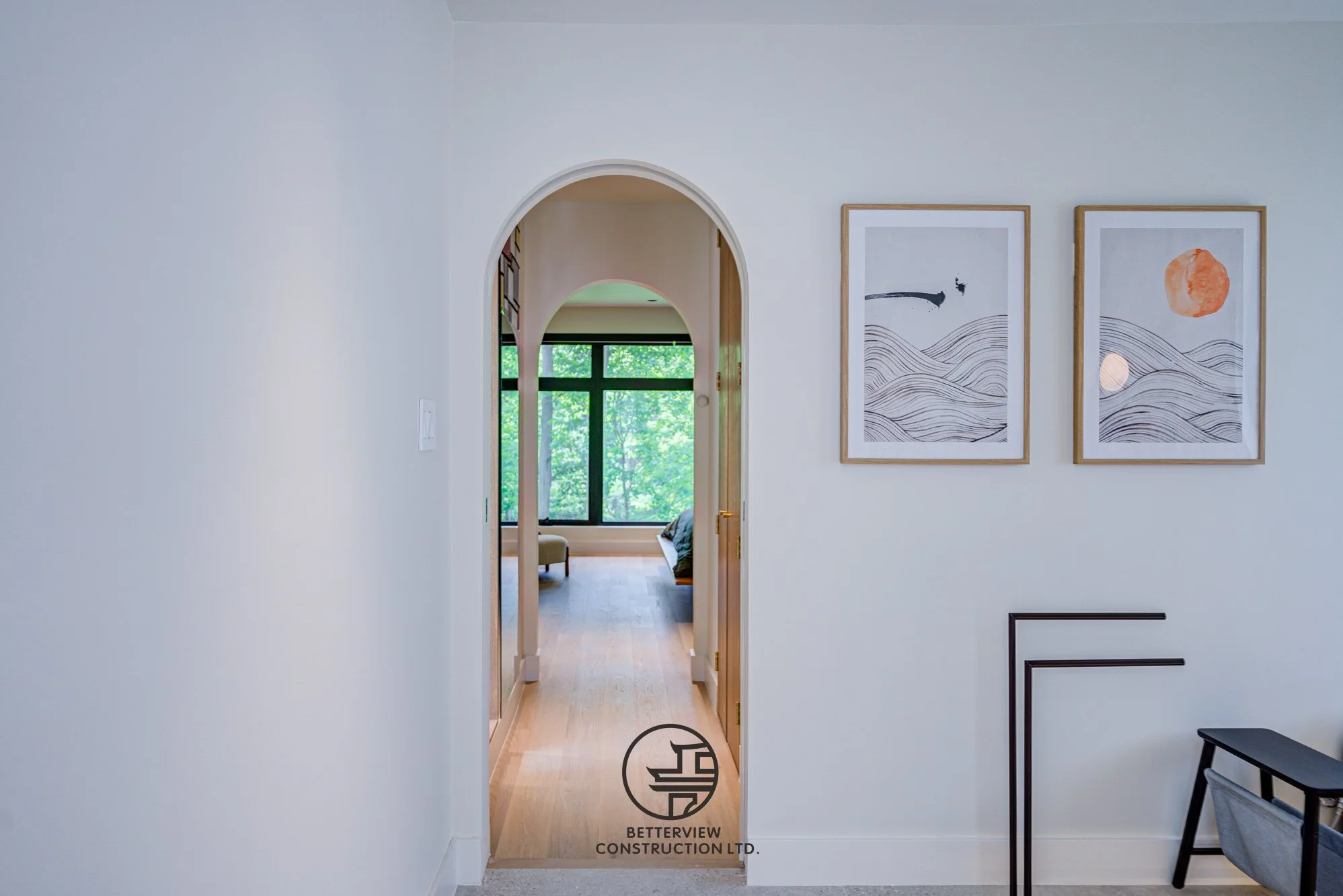 modern arched doorway connecting bathroom and bedroom in renovated home