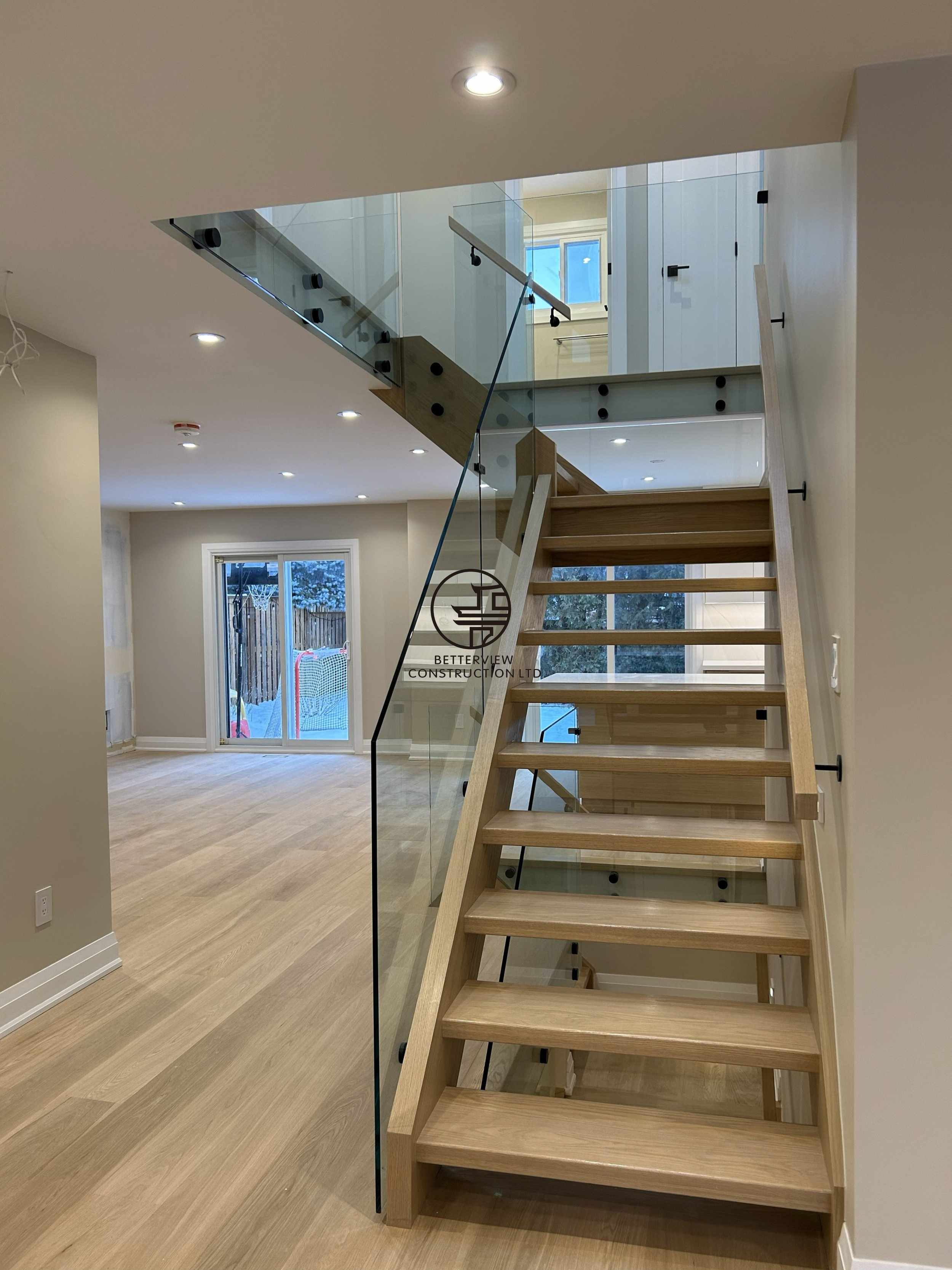 floating-wood-staircase-glass-railing-home-renovation.png.png