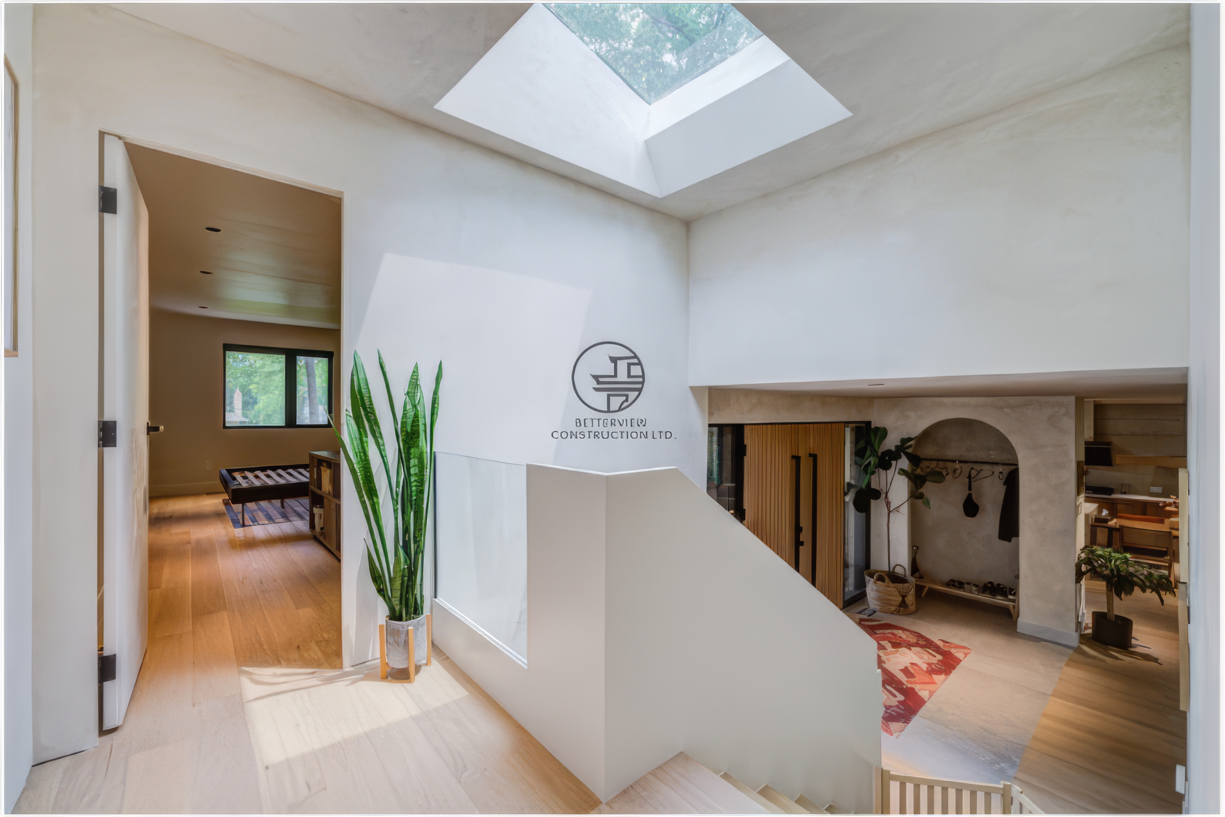 modern staircase landing with skylight bringing natural light into renovated home