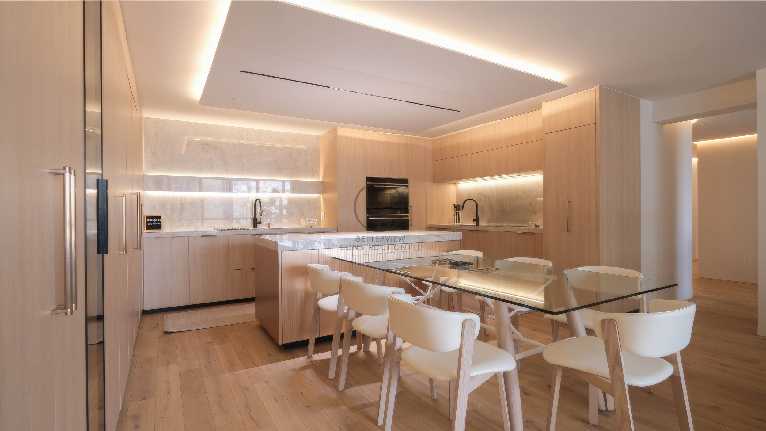 modern open concept condo kitchen with marble island and dining area