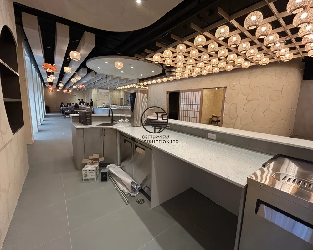 Modern restaurant dining area in Toronto with open kitchen layout, custom lighting ceiling design, and high-end interior renovation