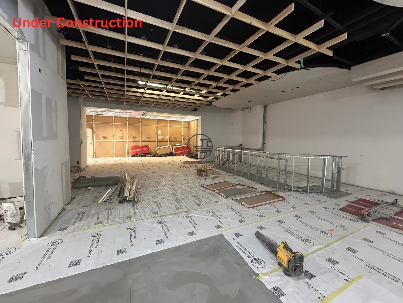 Restaurant renovation in Toronto showing ceiling grid framing installation, open layout construction, and early-stage commercial build