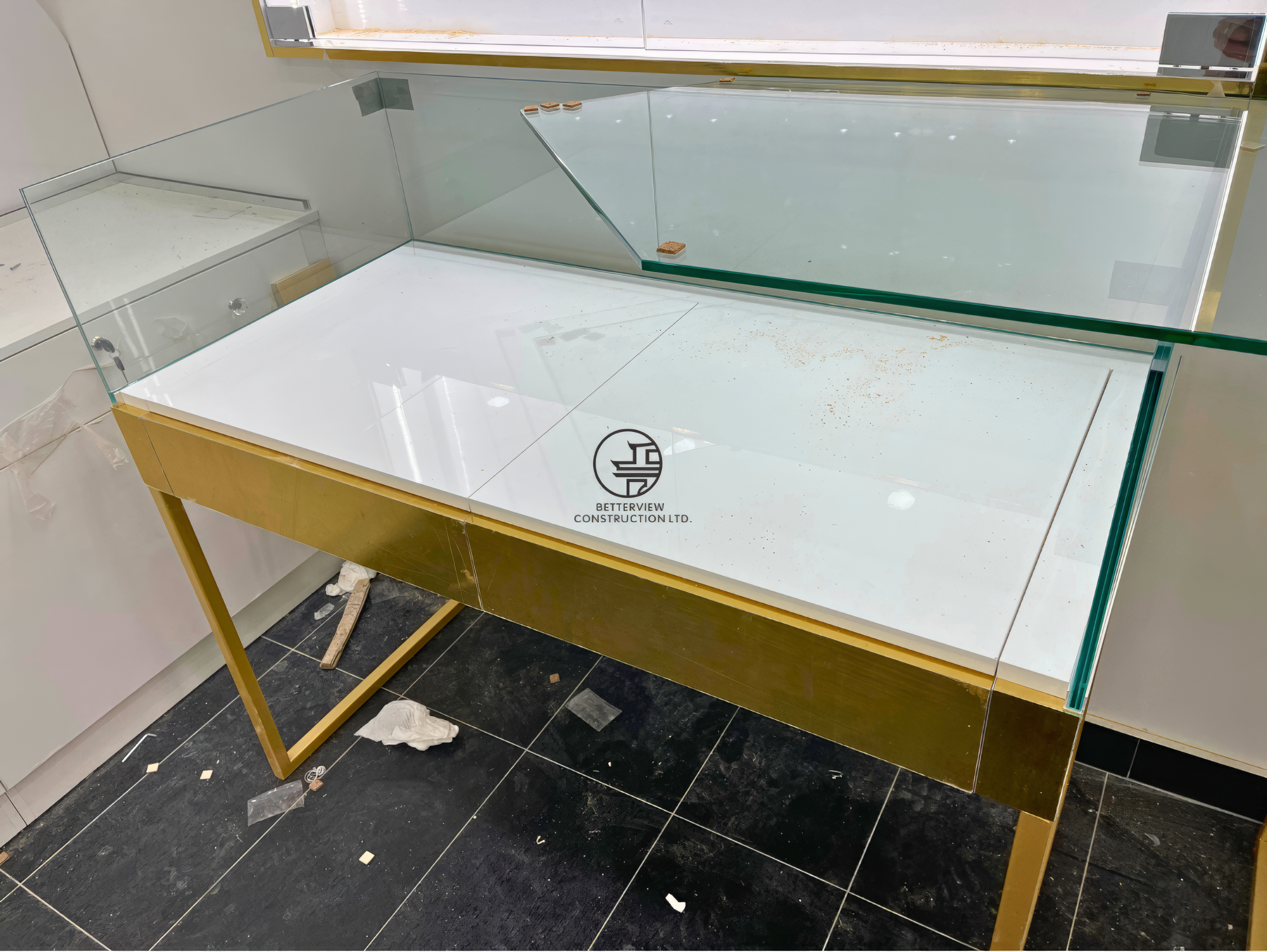 Custom glass display counter installation with metal frame in a luxury retail store renovation project in Toronto