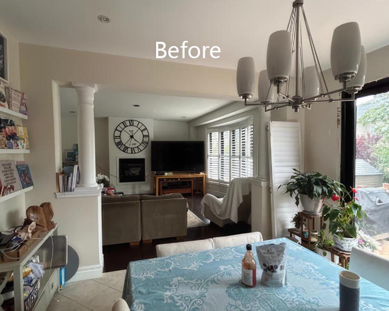 open dining and living area before renovation with chandelier tiled flooring and traditional layout in Toronto home interior
