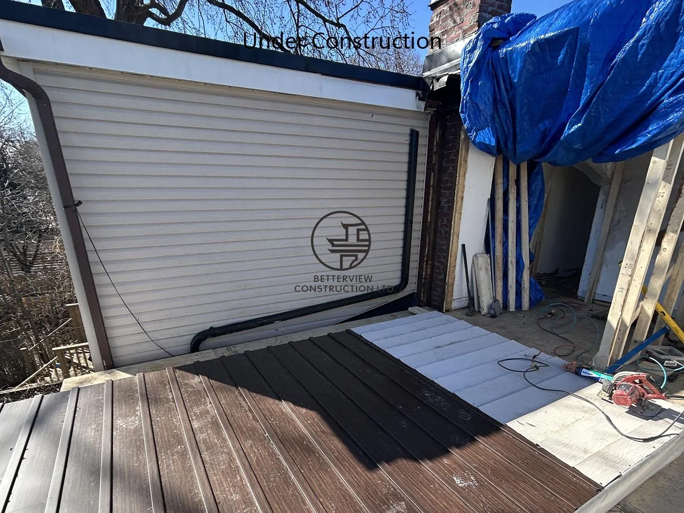 Modern rooftop deck under construction, expanding outdoor living space with a cantilevered second floor addition and contemporary home design.
