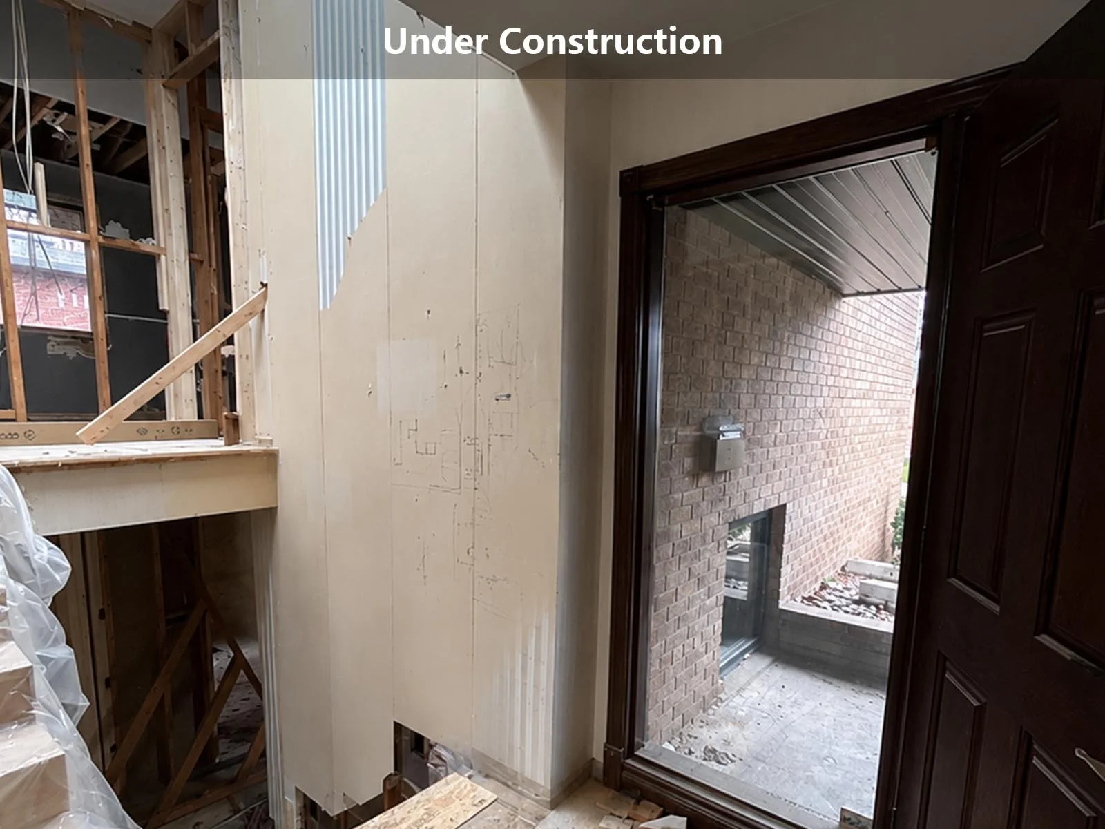 home entryway renovation under construction with staircase framing