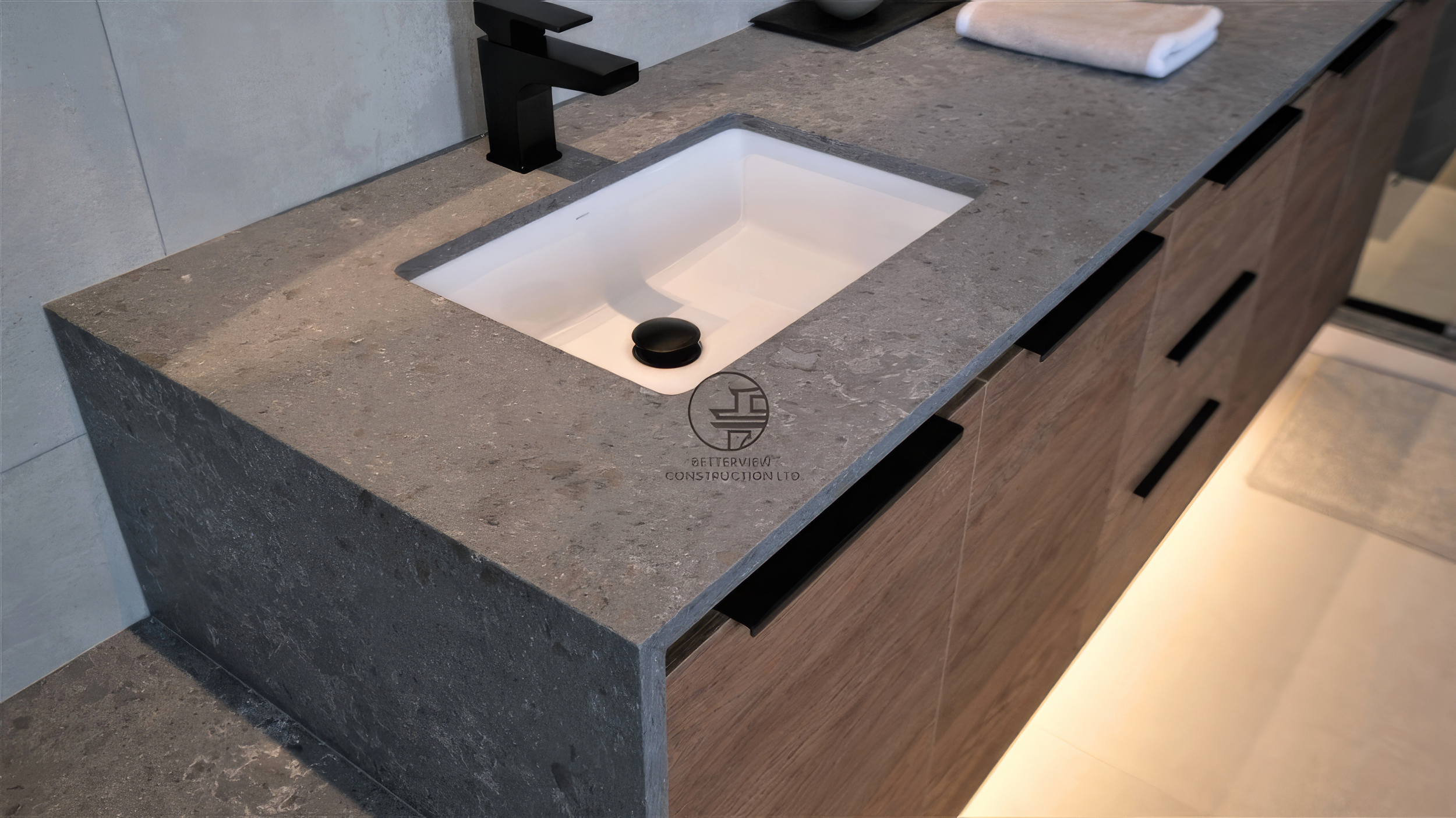 modern bathroom renovation vanity with stone countertop and black faucet