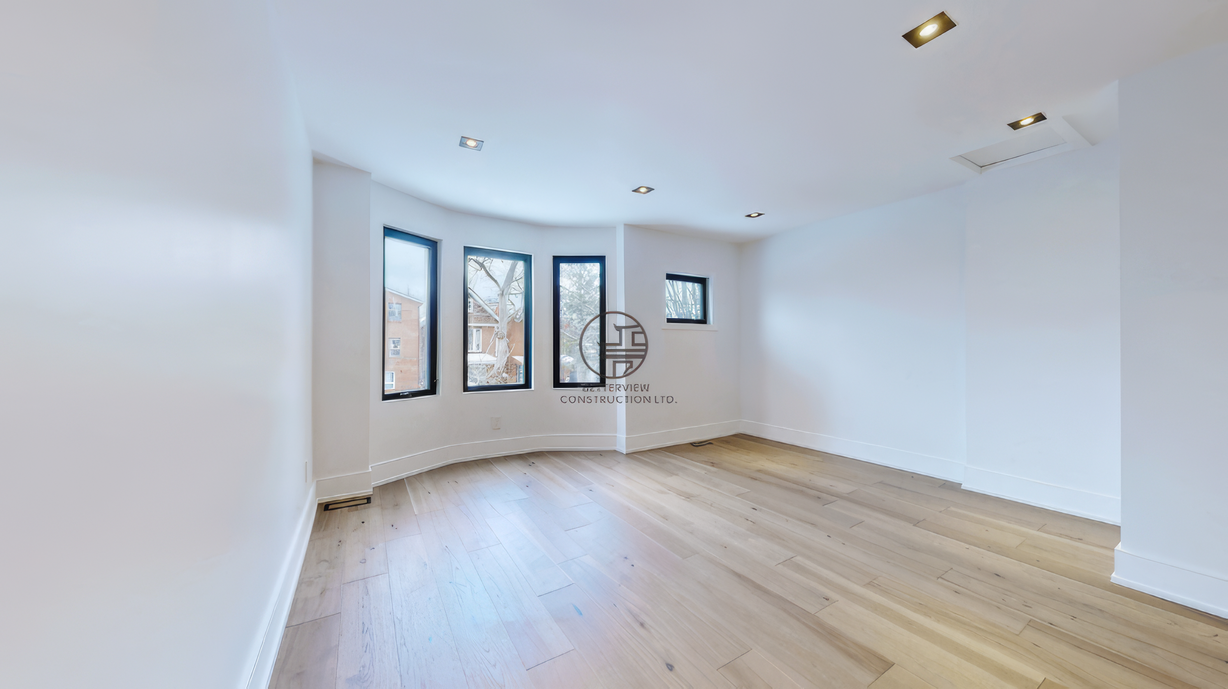 bright-room-with-curved-bay-windows-and-hardwood-floor.jpg.png