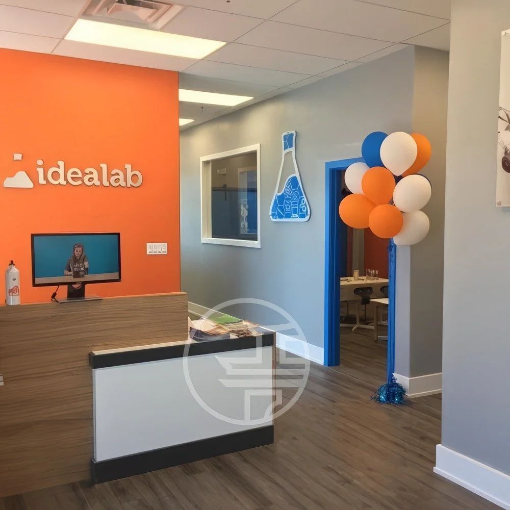 Modern commercial office reception renovation in Toronto featuring front desk design, branding wall, and welcoming workspace layout