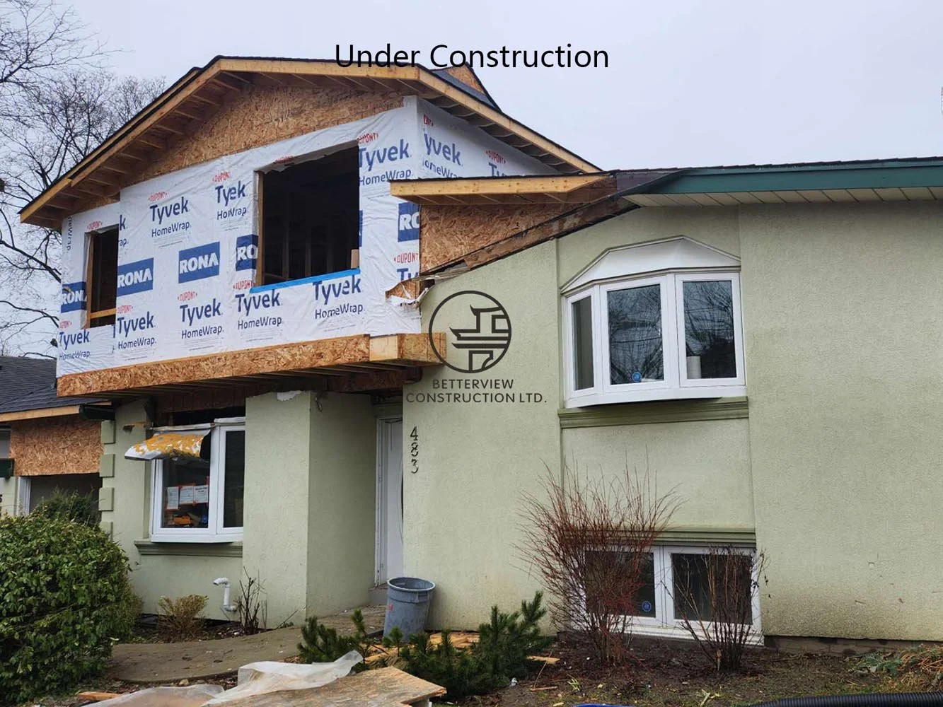 Exterior view of a second floor home addition during construction, featuring new framing, exterior sheathing, and expanded living space for a custom home renovation in Toronto.