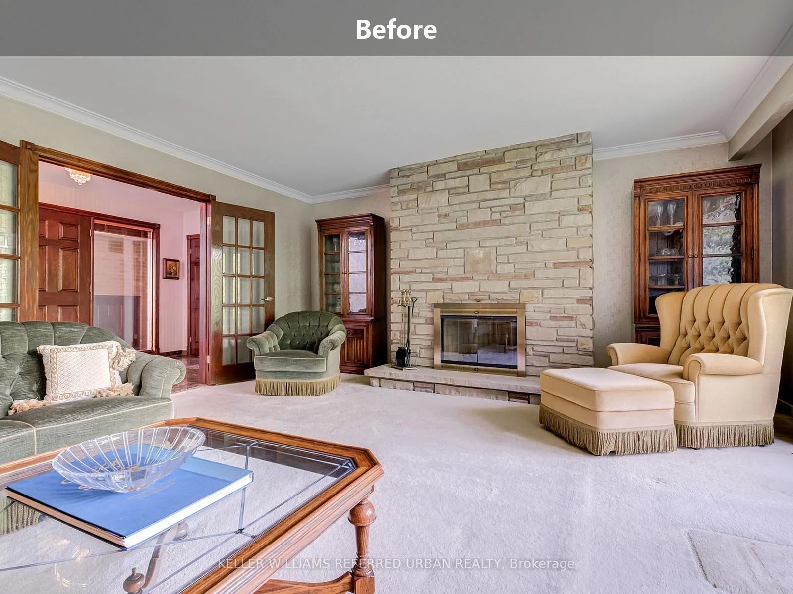 An outdated living room before a complete home renovation, featuring original wood paneling, aging finishes, and worn flooring.