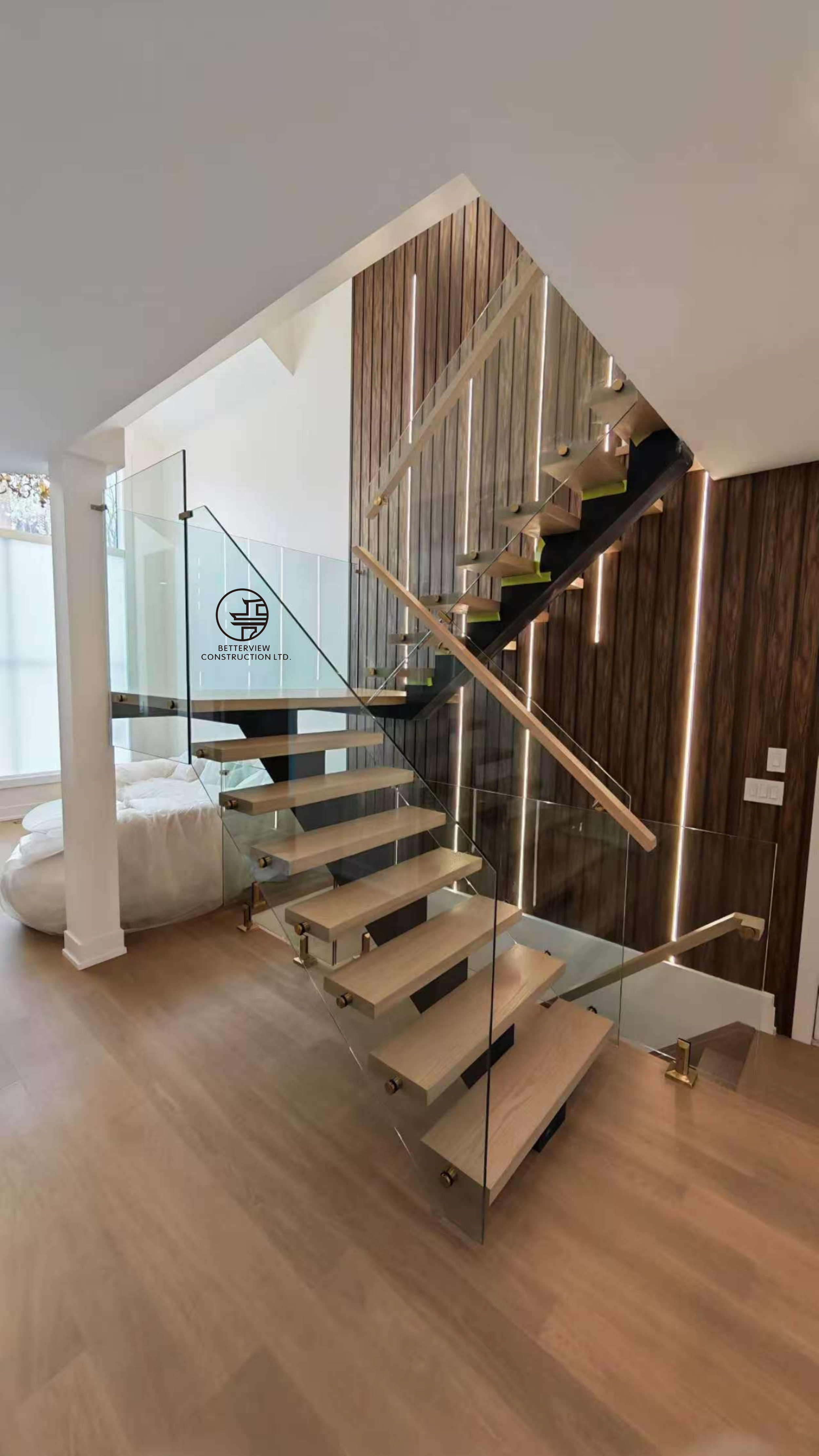 modern floating staircase with glass railing wood treads and vertical wood slat accent wall in Toronto home renovation