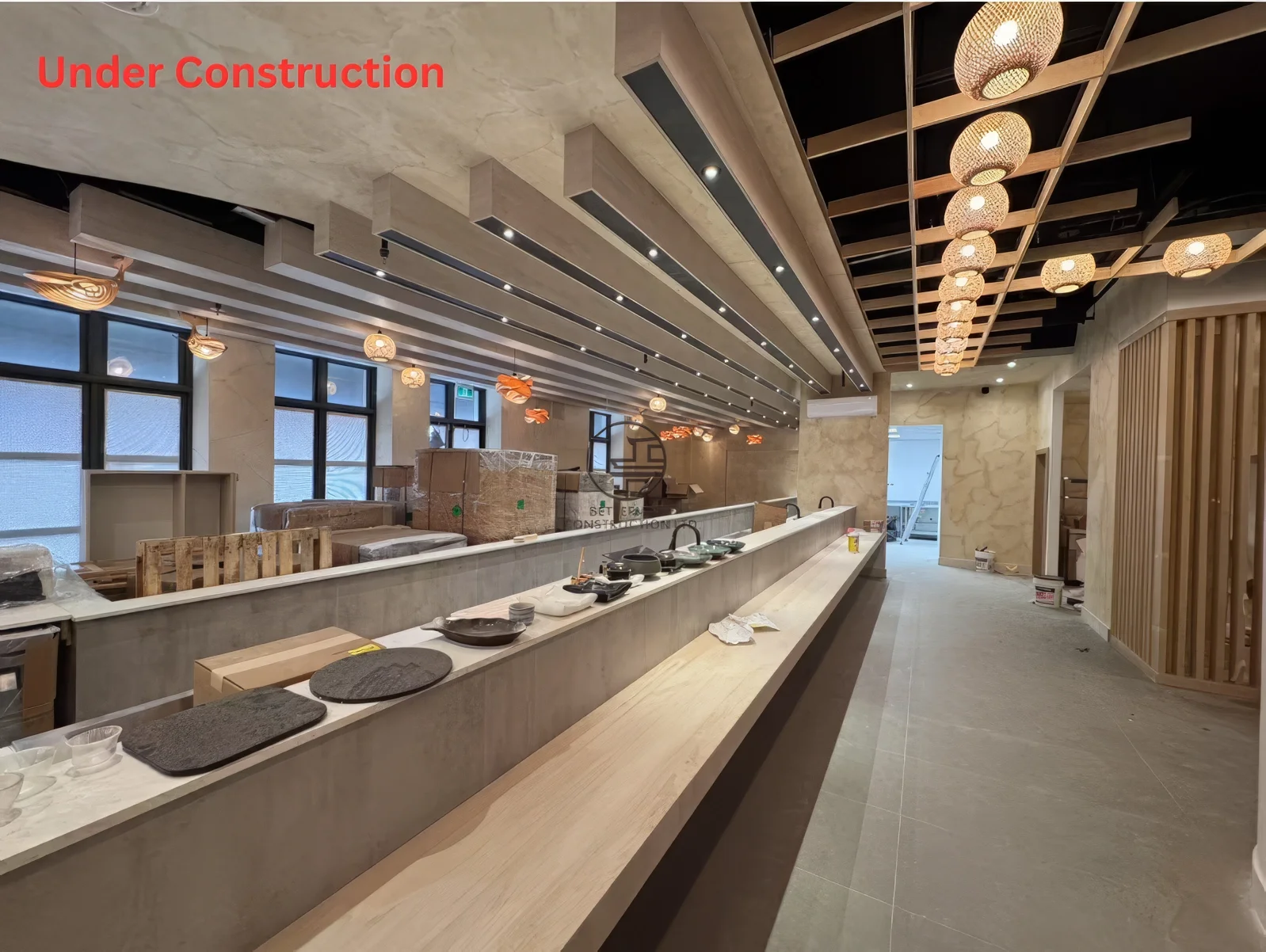 Japanese restaurant renovation near completion in Toronto featuring sushi bar interior, ceiling lighting design, and modern dining layout
