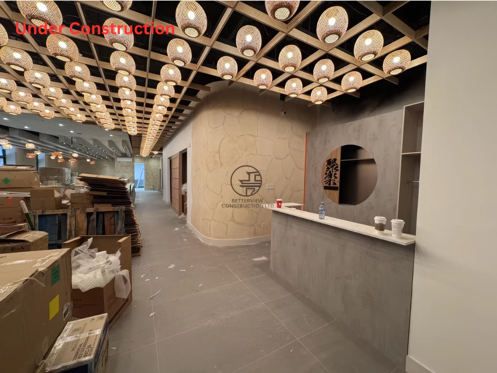 Restaurant renovation near completion in Toronto featuring reception area, custom front desk design, and Japanese-style interior lighting