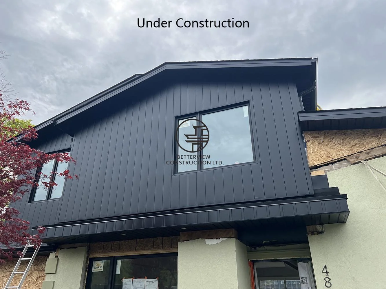 Modern black exterior cladding installed on a second floor home addition, creating a contemporary custom home design in the GTA.