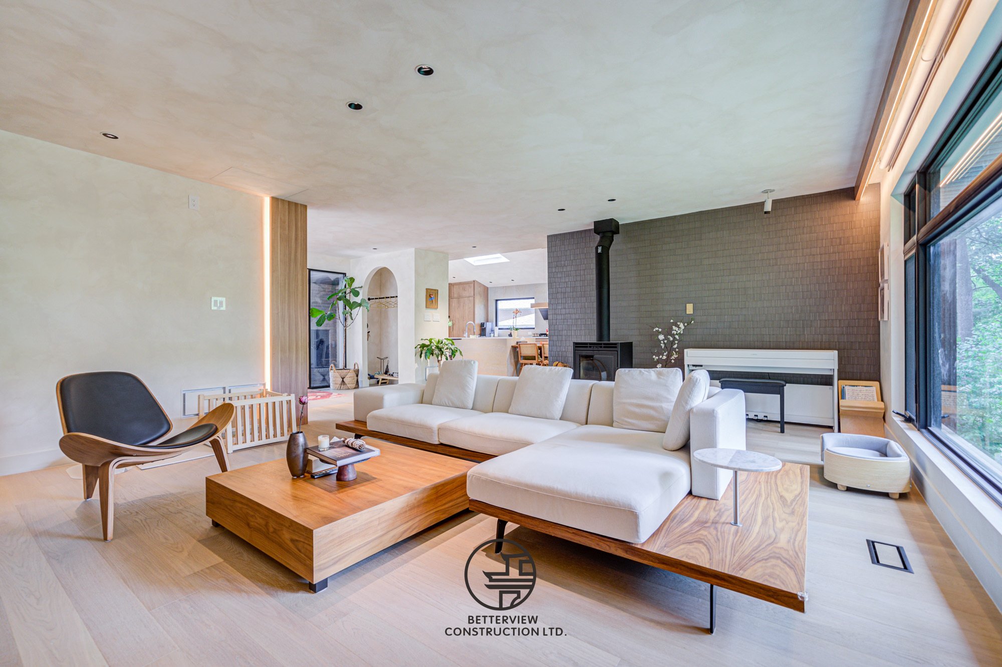 modern open concept living room with wood coffee table and large windows