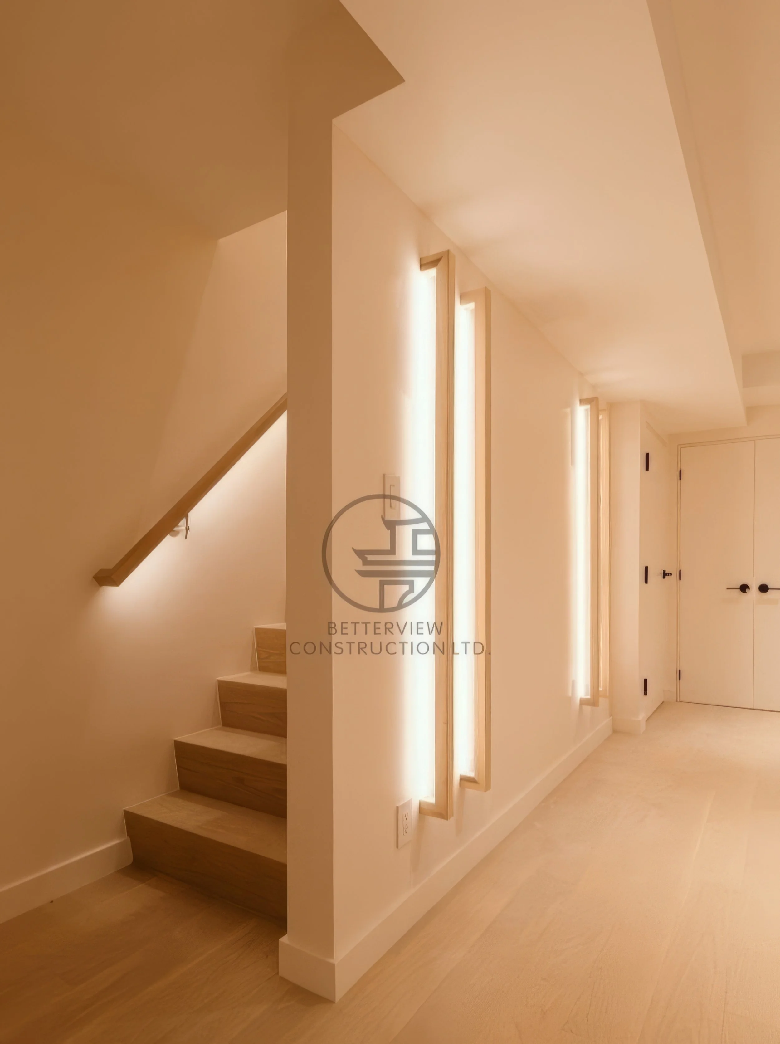 modern basement staircase with warm LED wall lighting and minimalist wood steps in home renovation project