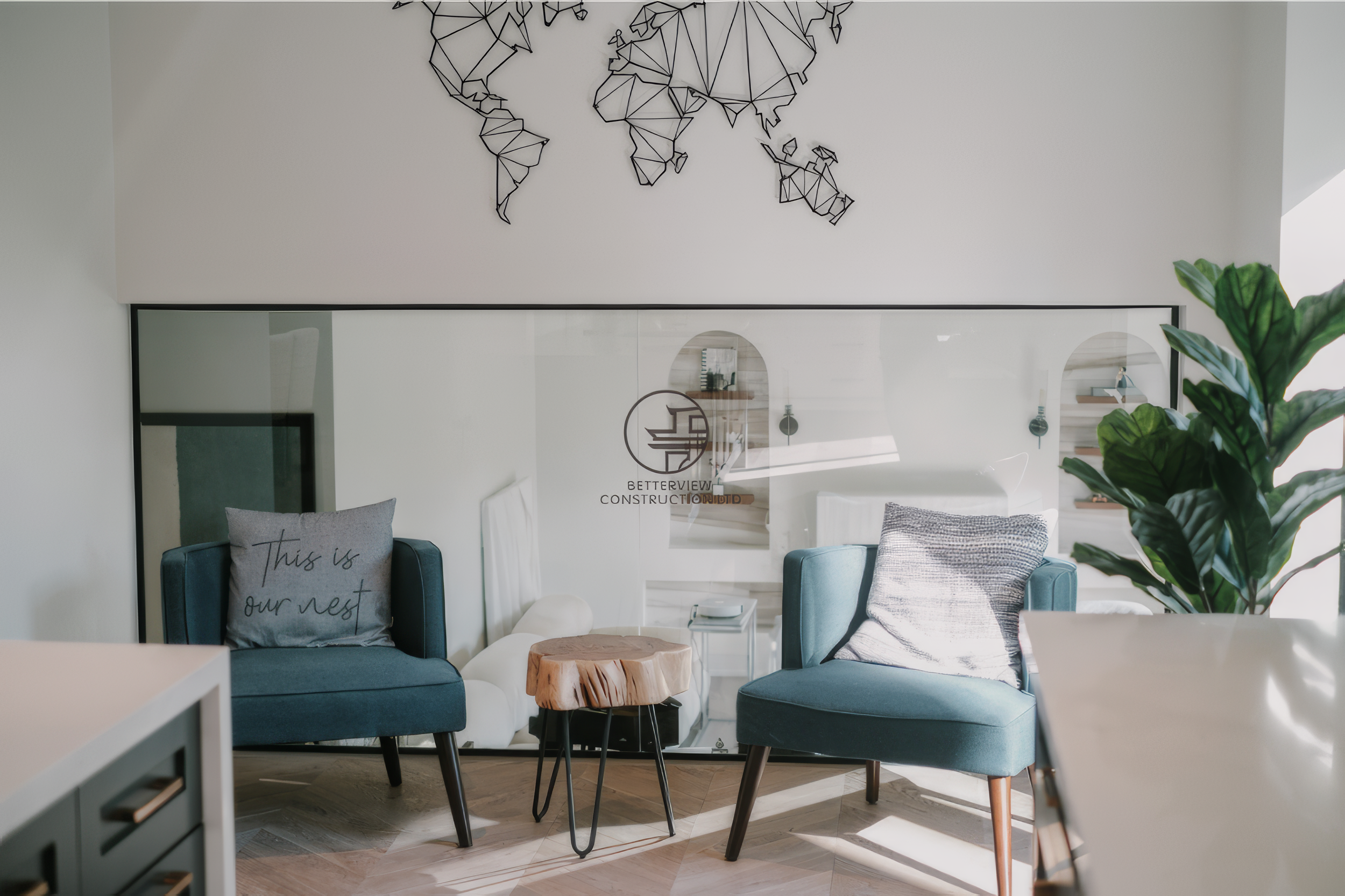 Modern seating nook renovation with accent chairs, glass railing, and minimalist interior design in a Toronto home.