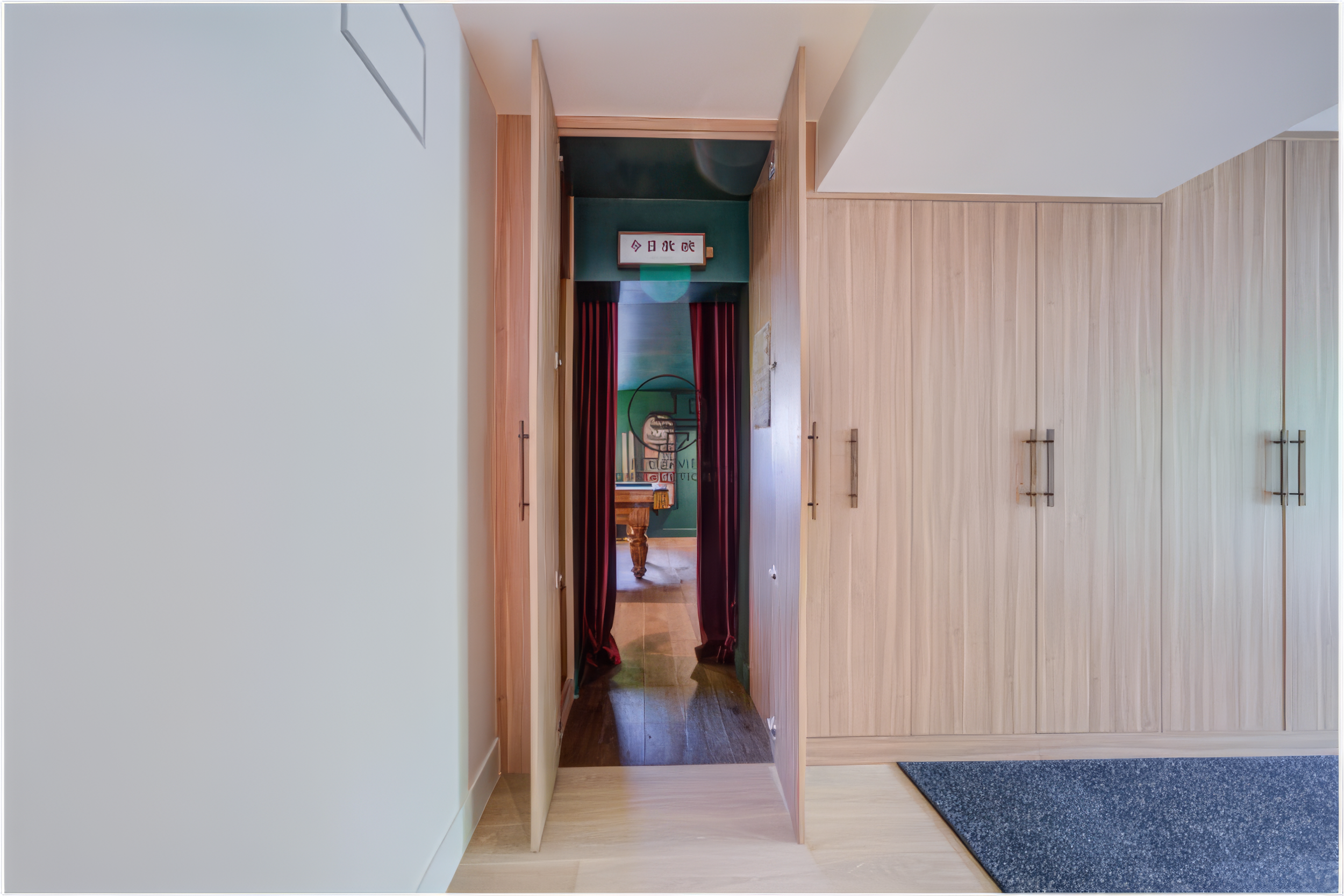 finished basement renovation with custom cabinetry and concealed door