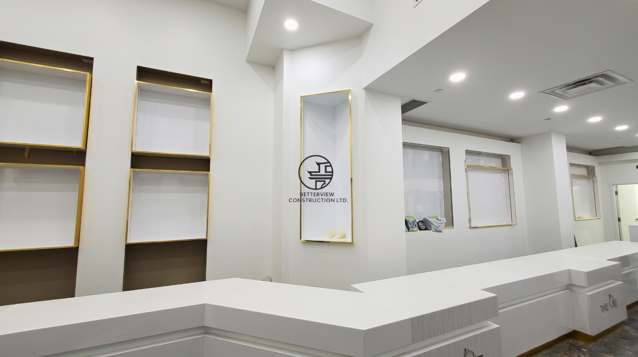 Luxury jewelry store interior with custom white counter and gold display wall after commercial renovation in Toronto