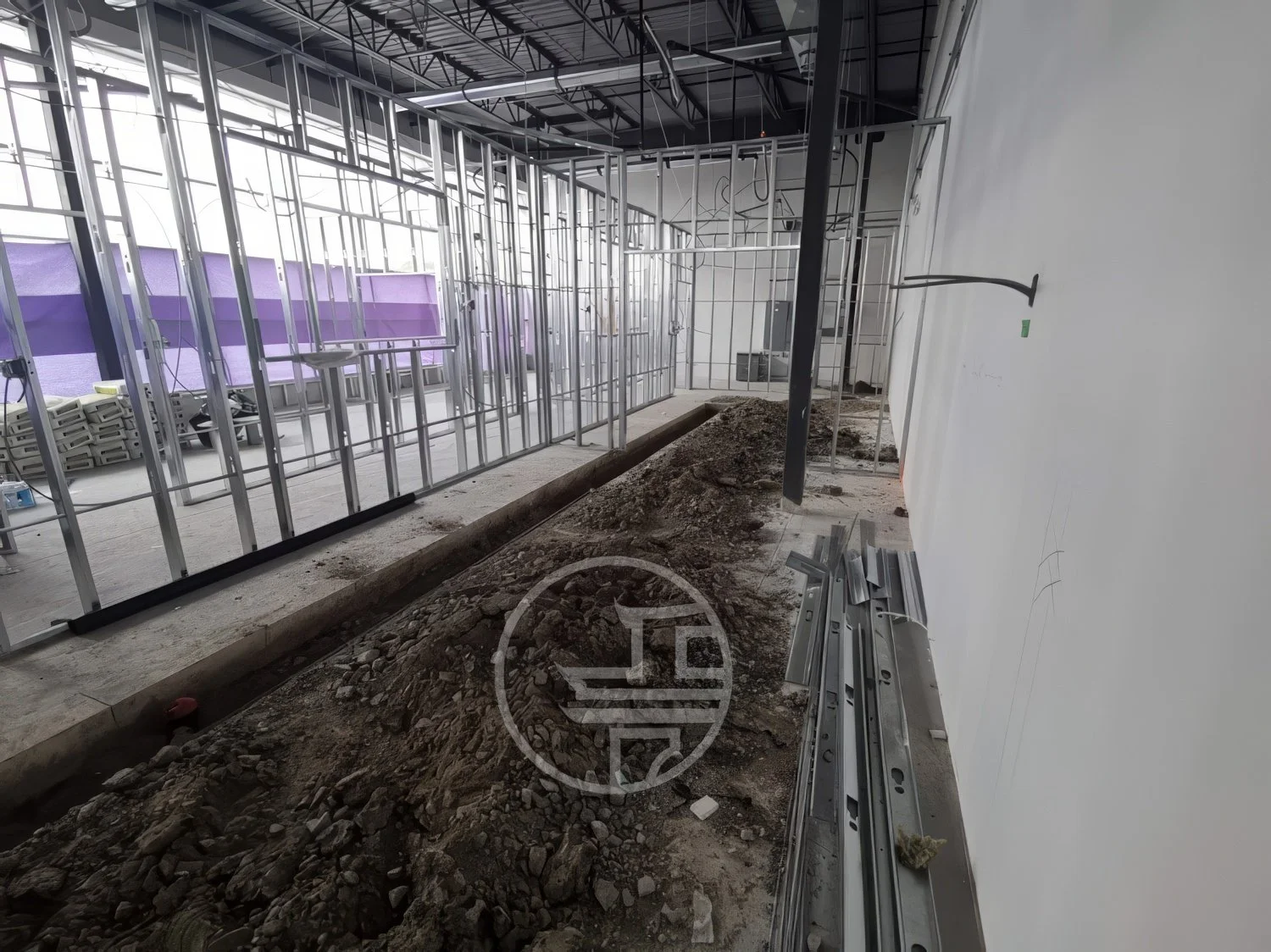 Commercial interior renovation with demolition and trenching work for plumbing and foundation preparation in Toronto construction site