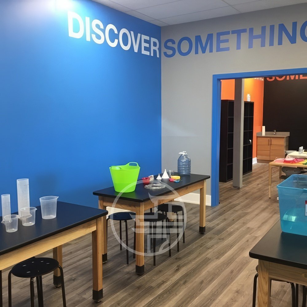 Education center renovation in Toronto featuring modern classroom layout, collaborative work tables, and branded interior design elements