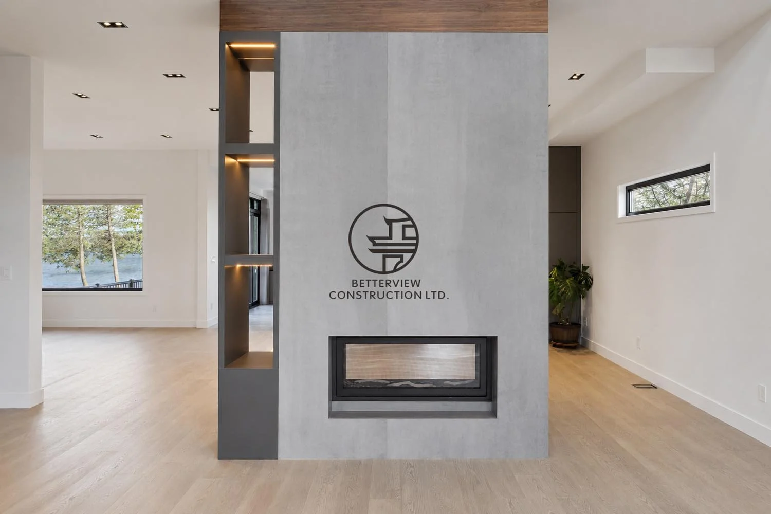 Minimalist modern fireplace feature wall with built-in shelving, open-concept living space, light wood flooring, and clean contemporary interior design.