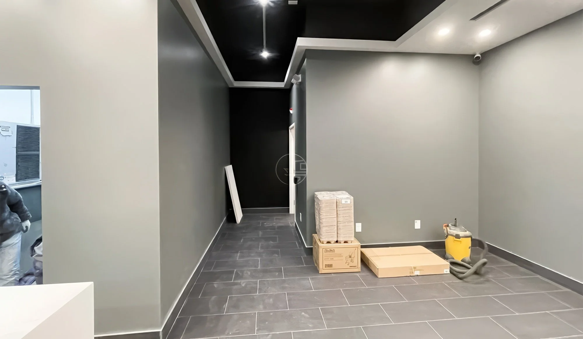 Open commercial retail interior renovation in Toronto featuring modern layout, tiled flooring, and clean minimalist design ready for business setup