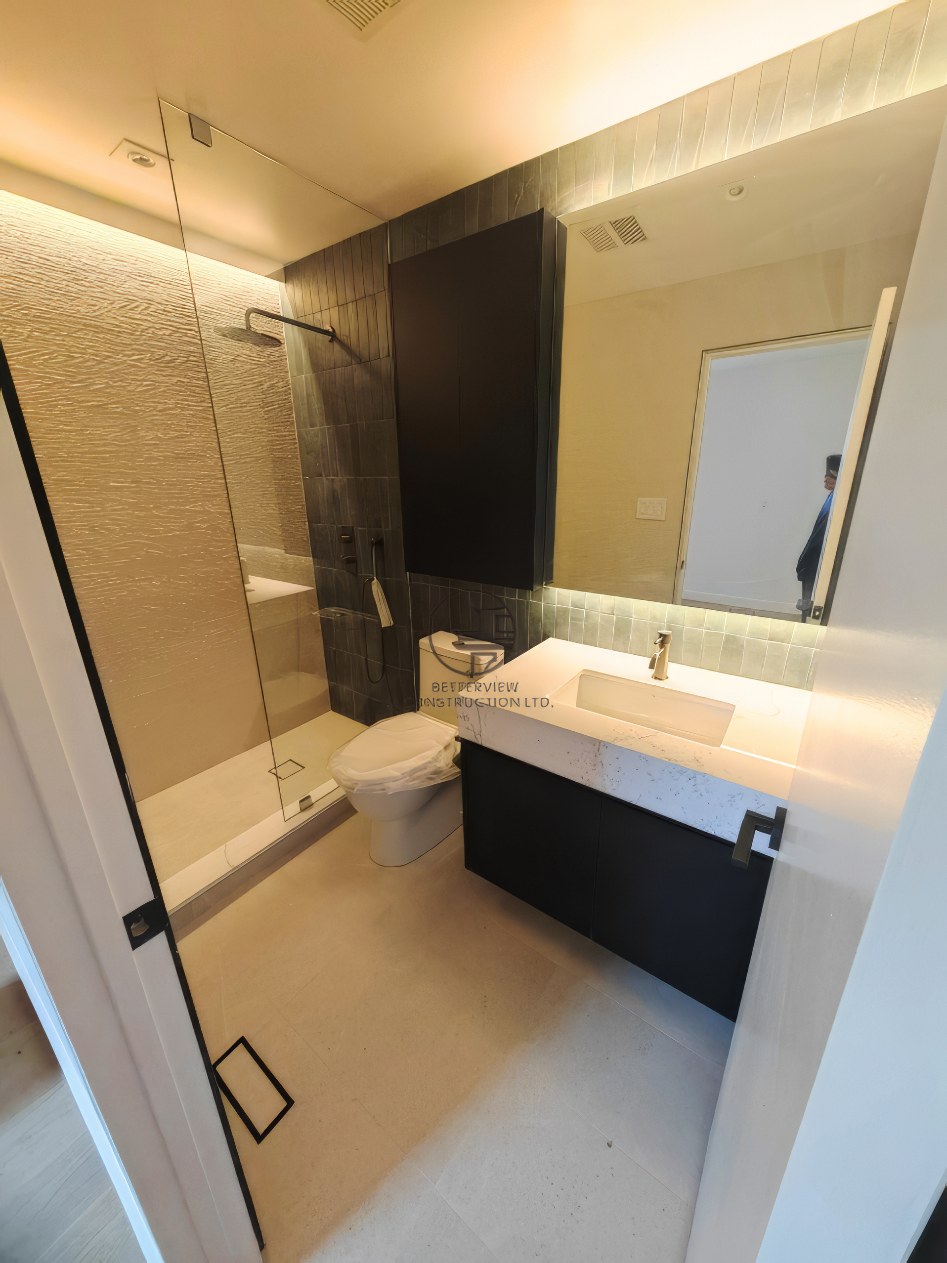 modern bathroom renovation with glass shower, floating vanity, and large mirror in contemporary home