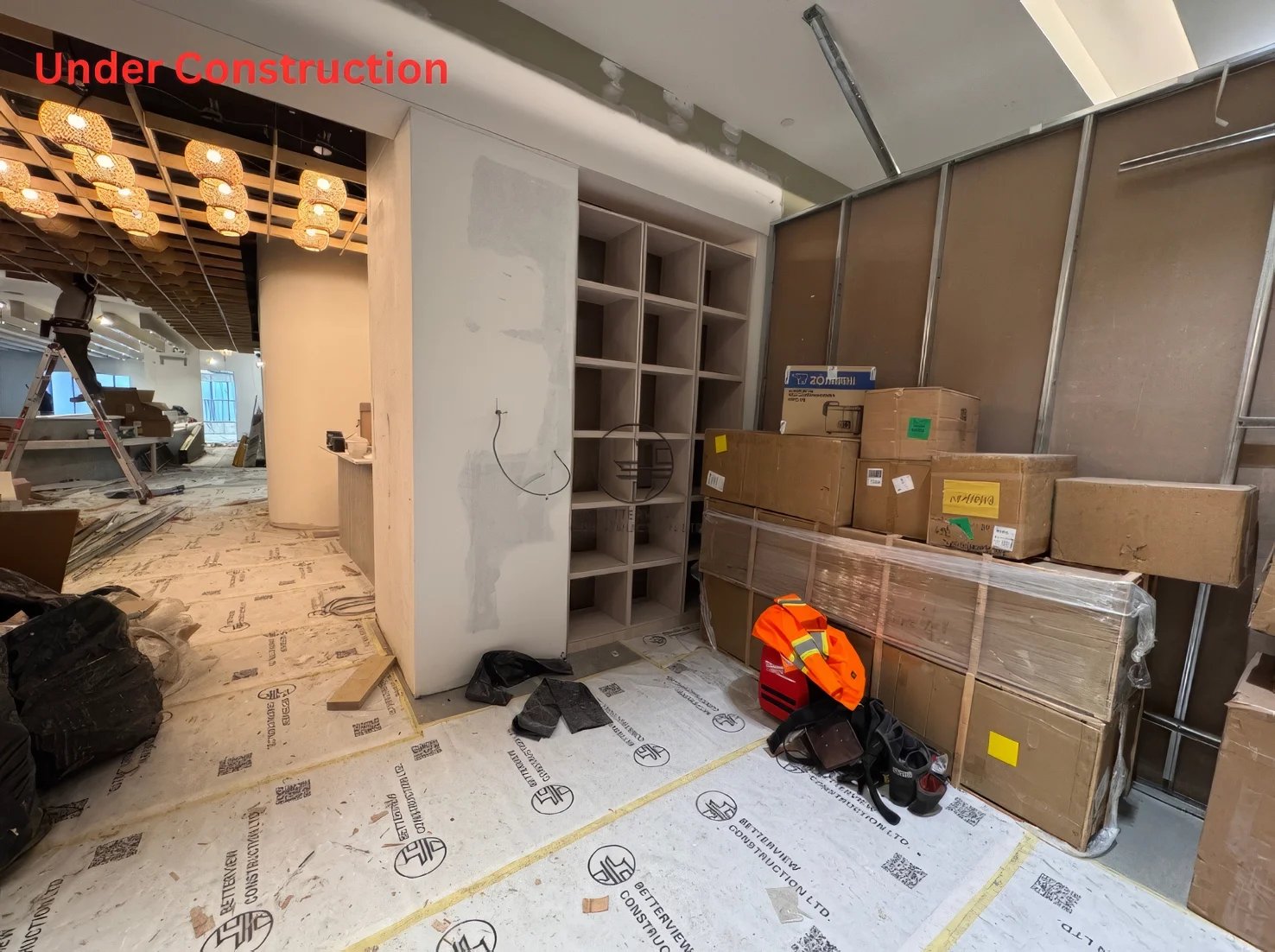 Restaurant renovation under construction in Toronto showing custom cabinetry installation, drywall finishing, and interior build-out progress