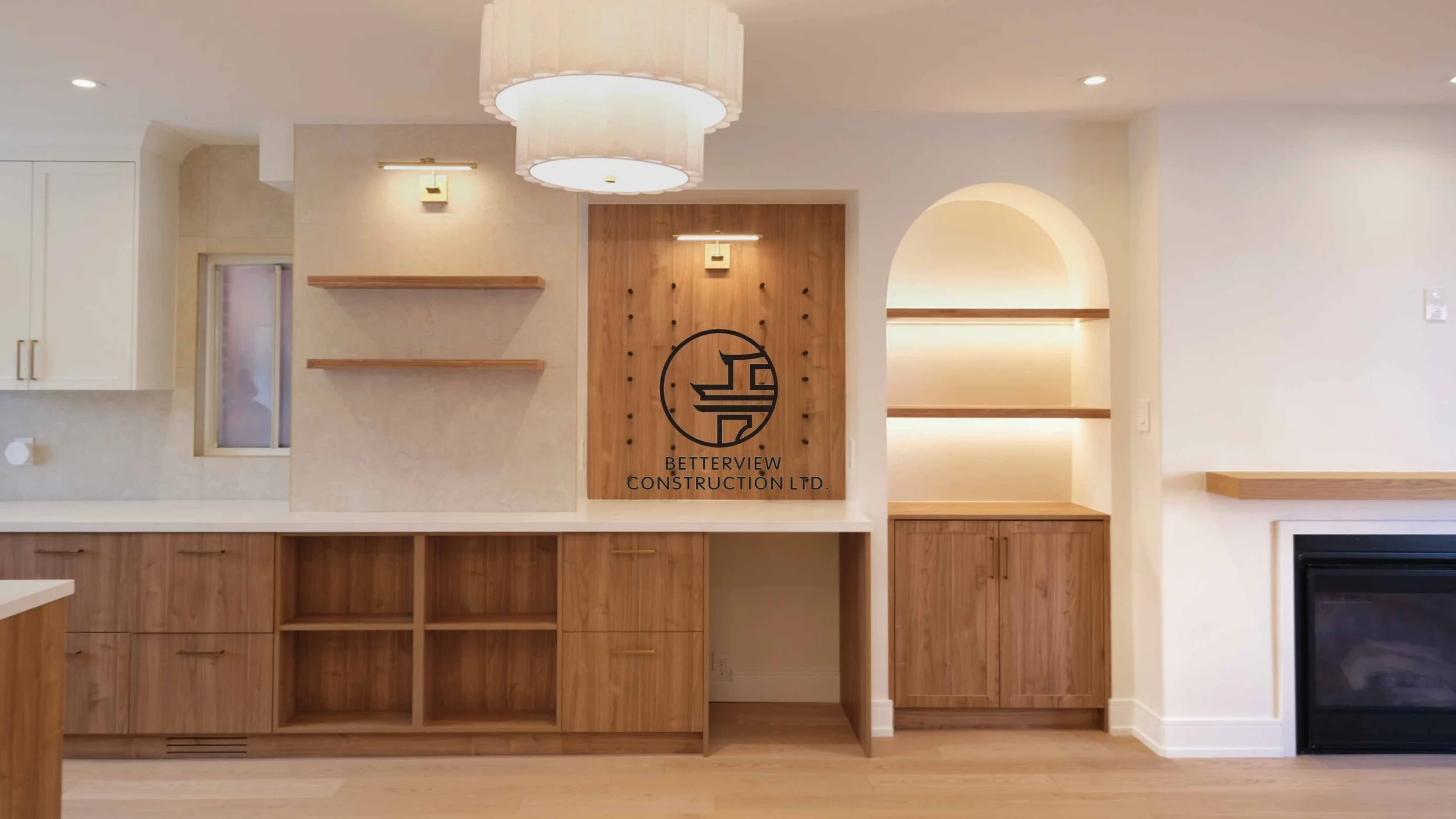 Modern open-concept living room and kitchen designed and built by Betterview Construction Ltd., featuring custom millwork and a clean contemporary interior design style, showcasing high-quality residential renovation, construction, and interior finis