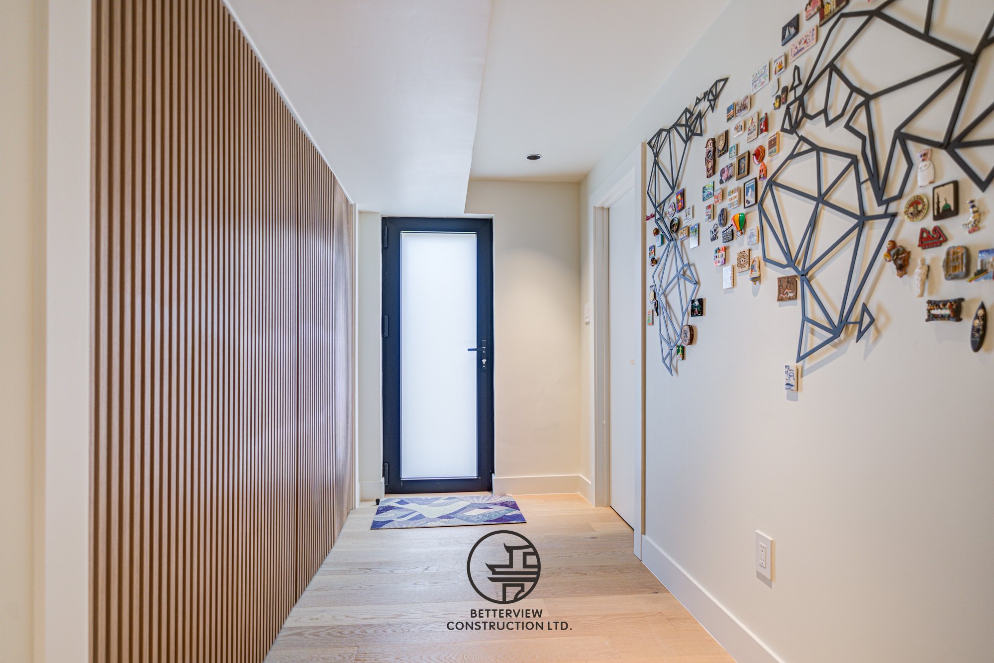 modern home entryway renovation with wood slat accent wall and minimalist design