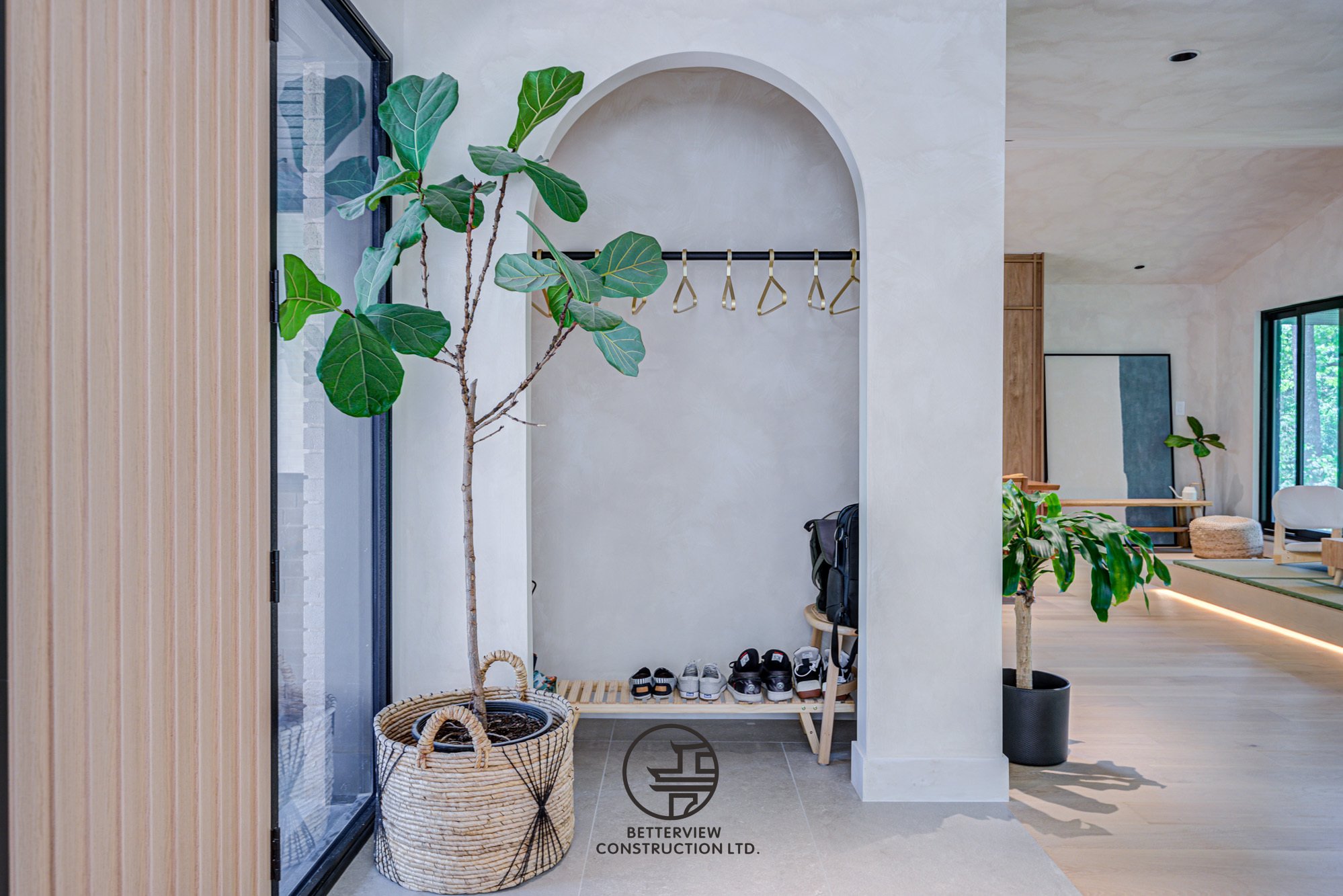 modern entryway storage nook with coat rack and arched niche
