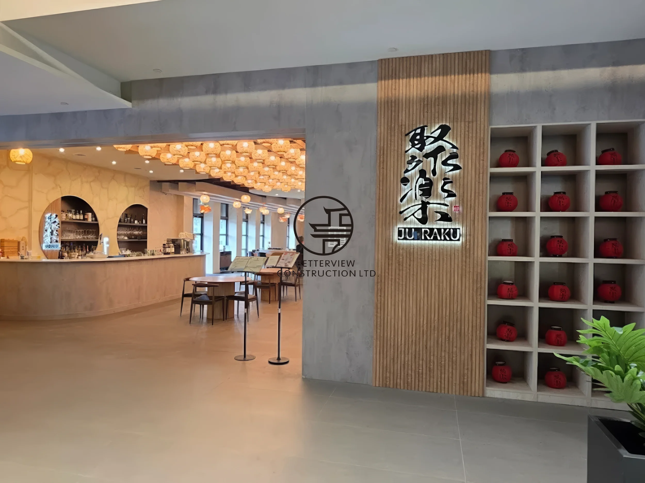 Modern restaurant interior entrance design in Toronto featuring custom wood panel branding wall, decorative shelving, and upscale dining atmosphere