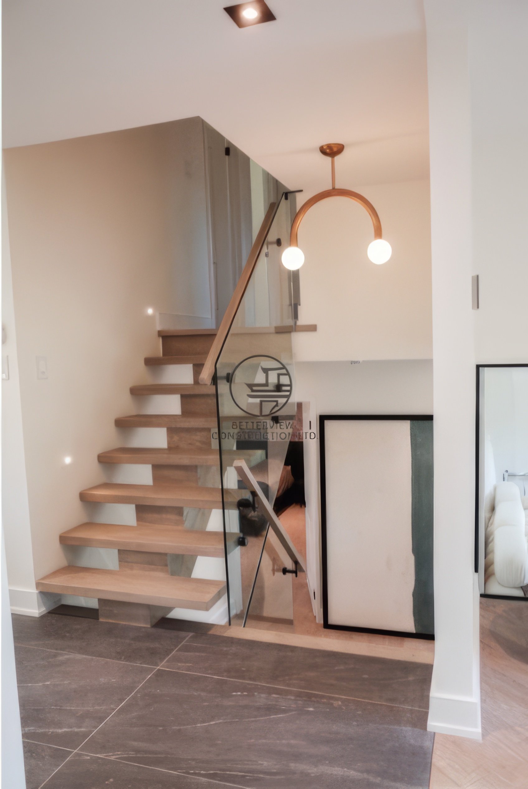Modern staircase renovation with floating wood steps, glass railing, and contemporary interior design in a Toronto home.