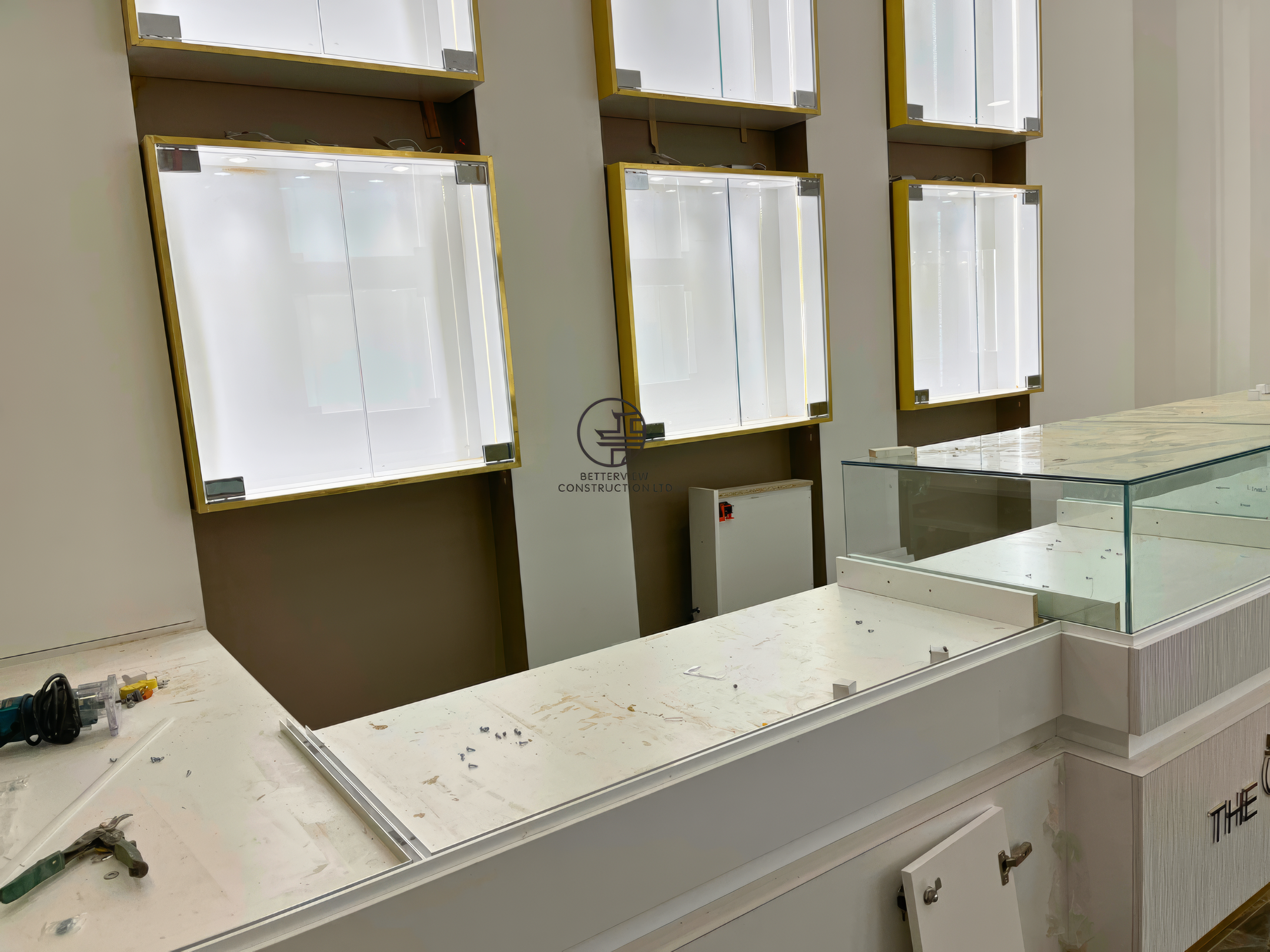 Close-up of custom retail display counter and wall showcase installation during commercial renovation in Toronto