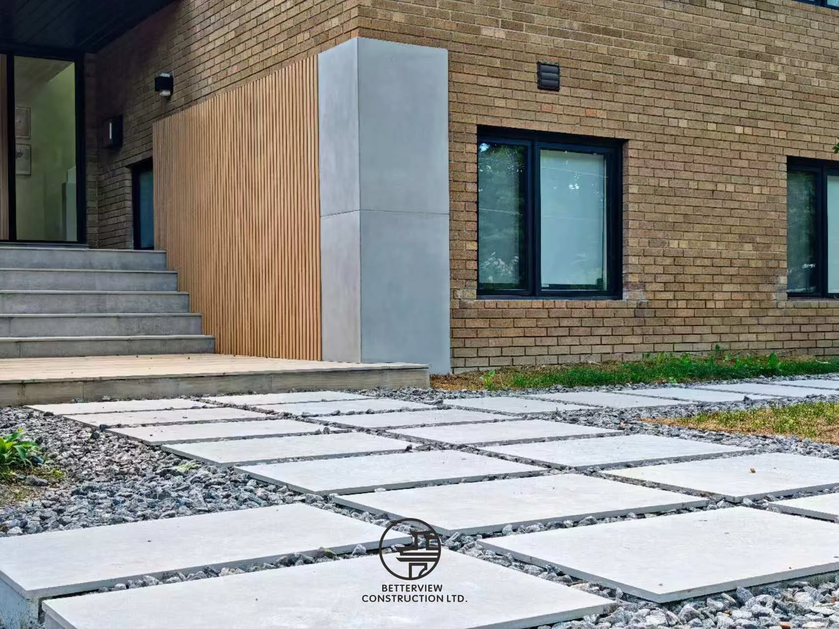 modern home exterior entrance with concrete steps and wood accent wall