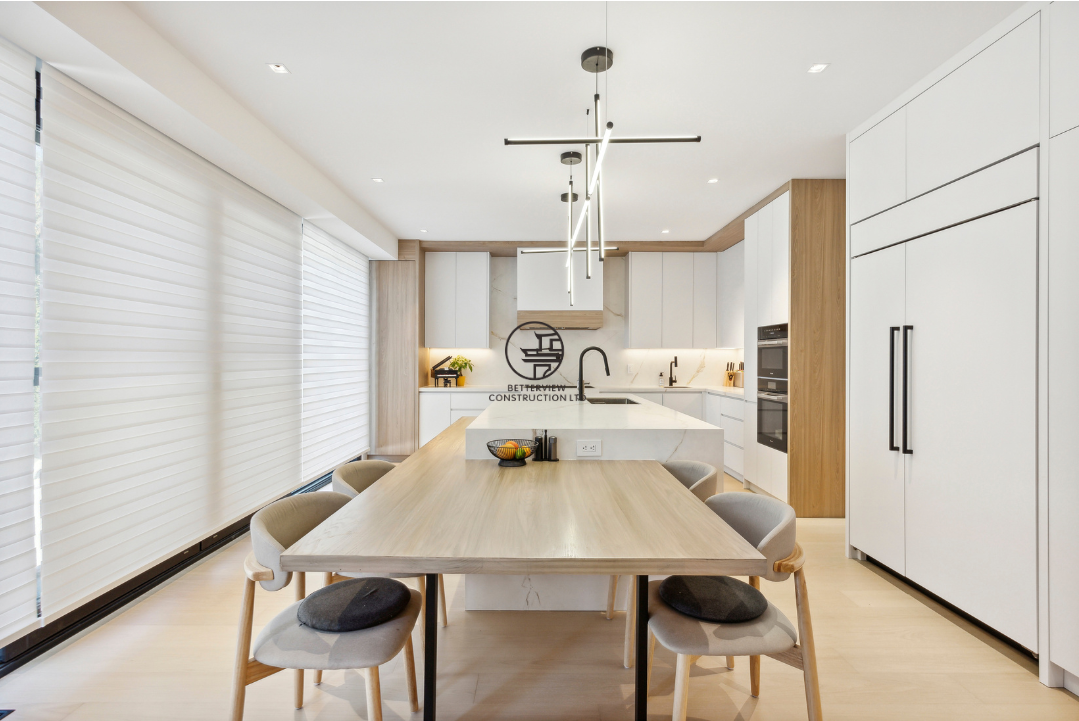 Modern kitchen and dining renovation featuring a custom island, integrated dining table, sleek cabinetry, and contemporary lighting in a GTA home