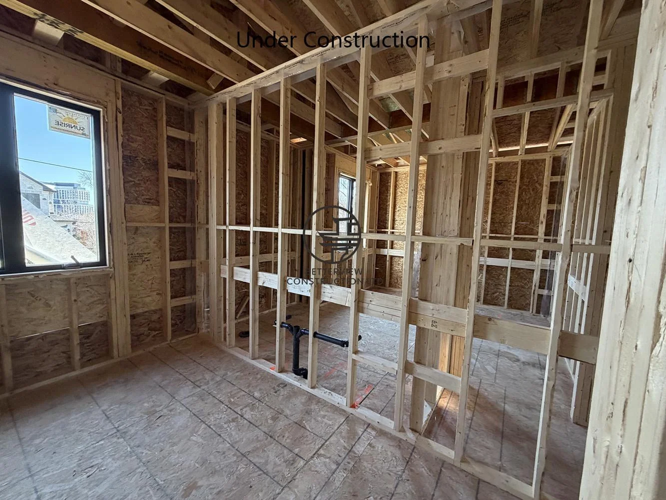 Interior wall framing for a custom home renovation, showing room layout before electrical, plumbing, and drywall installation.