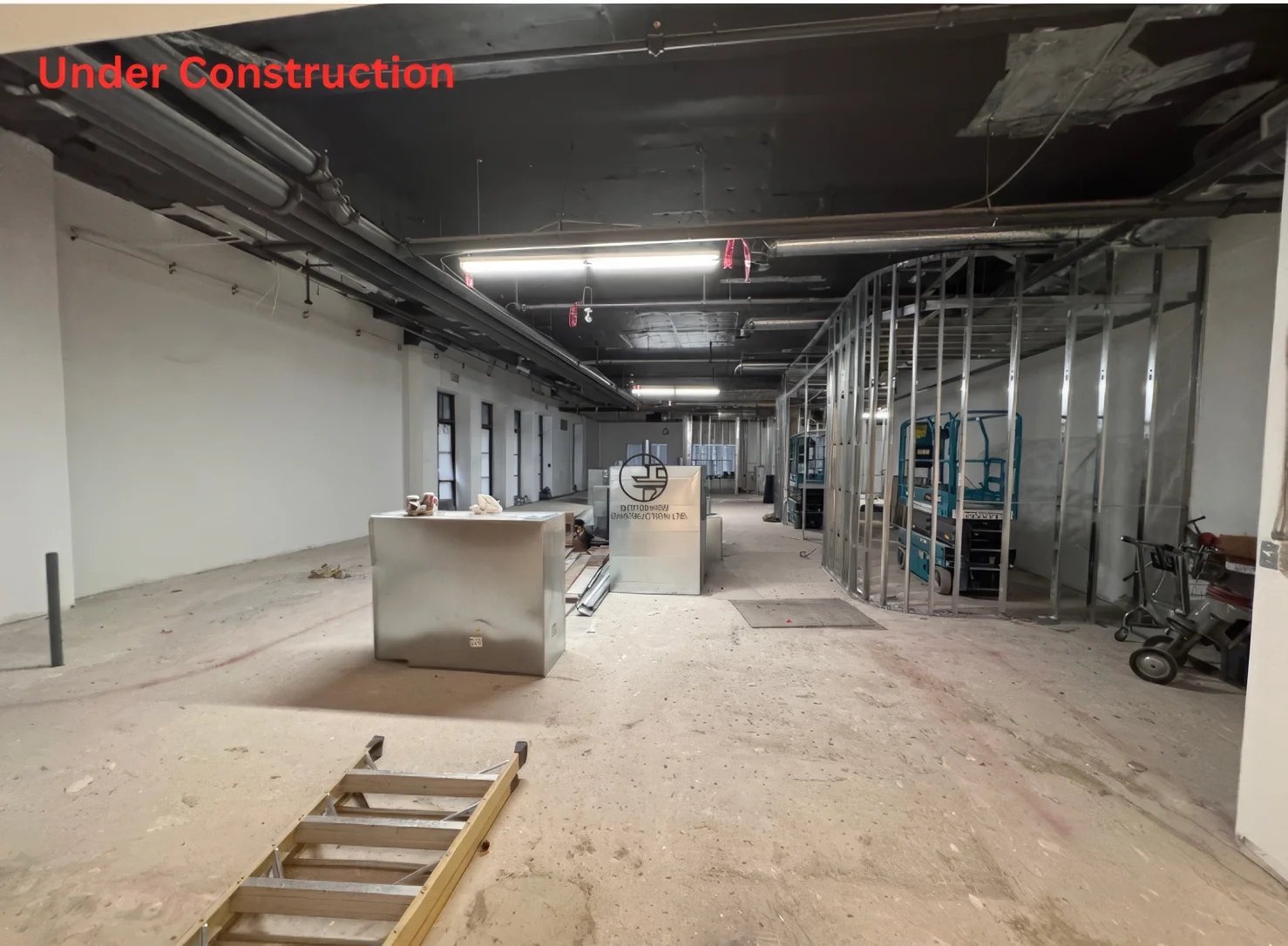 Commercial interior renovation under construction in Toronto with steel stud framing, exposed ceiling, and open layout build-out
