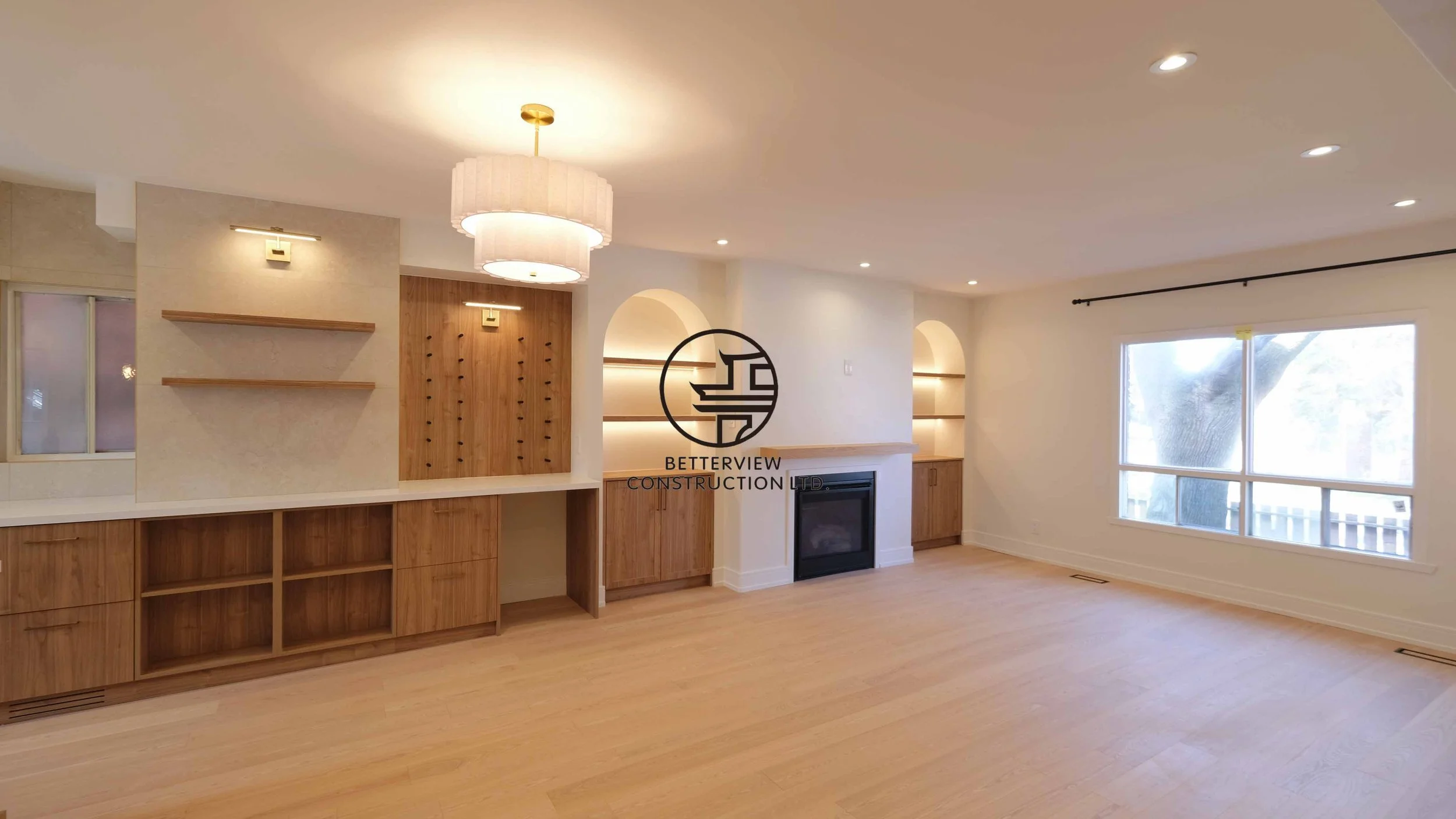 Modern open-concept living room and kitchen designed and built by Betterview Construction Ltd., featuring custom millwork and a clean contemporary interior design style, showcasing high-quality residential renovation, construction, and interior finis