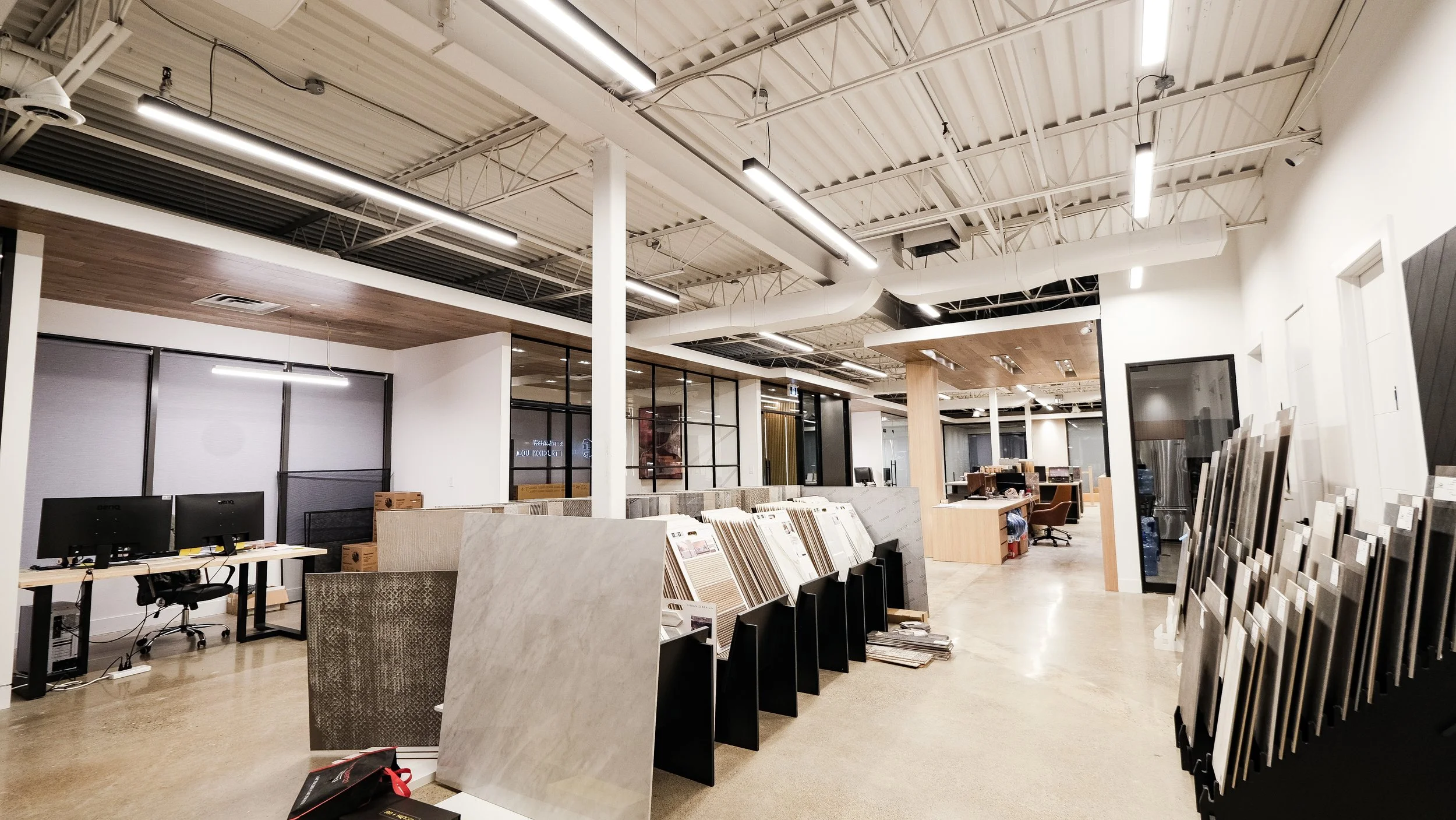 Betterview Construction showroom with material display area, flooring samples, and modern commercial interior in Toronto GTA