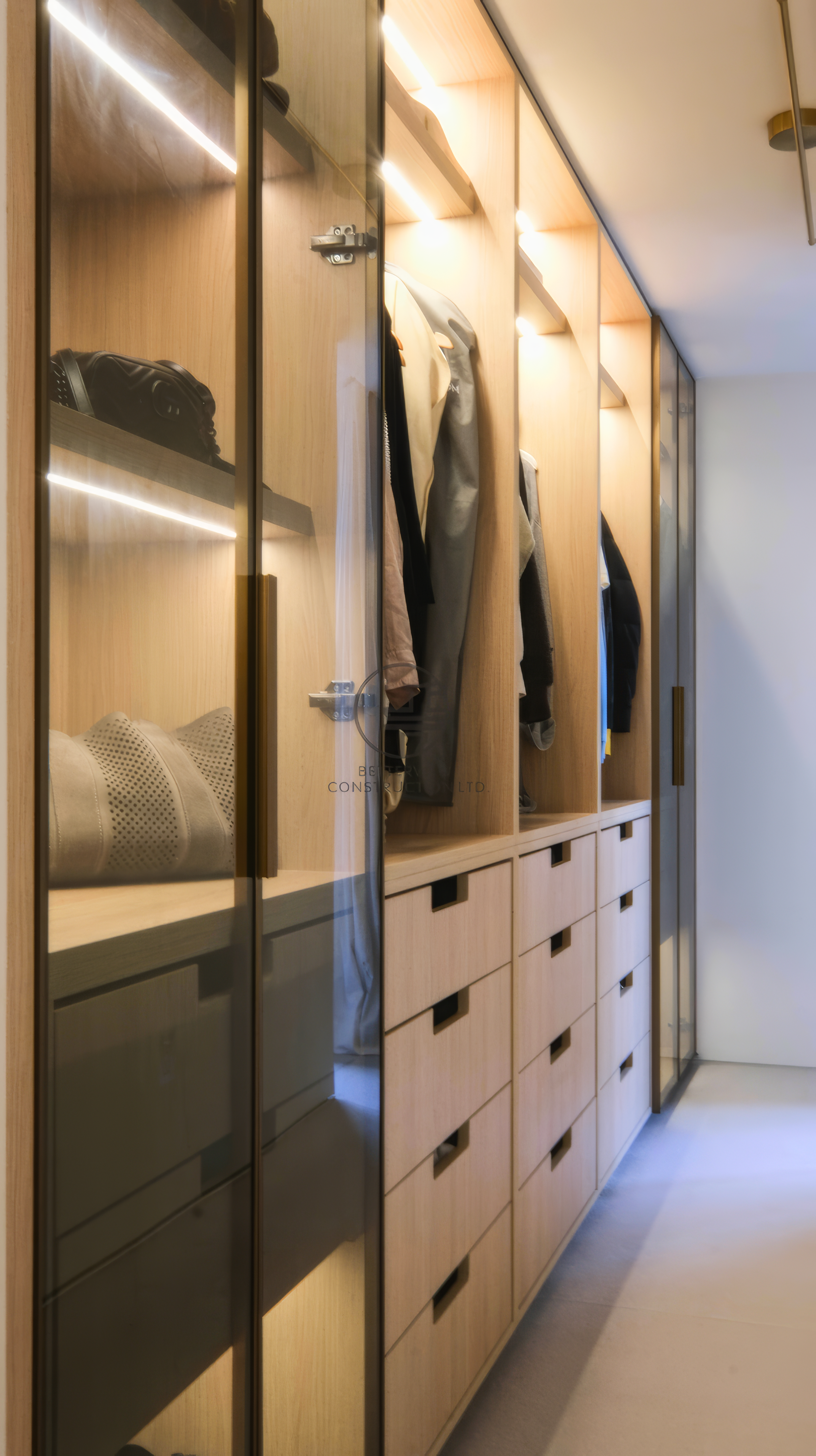 custom walk-in closet with built-in wardrobe and drawers