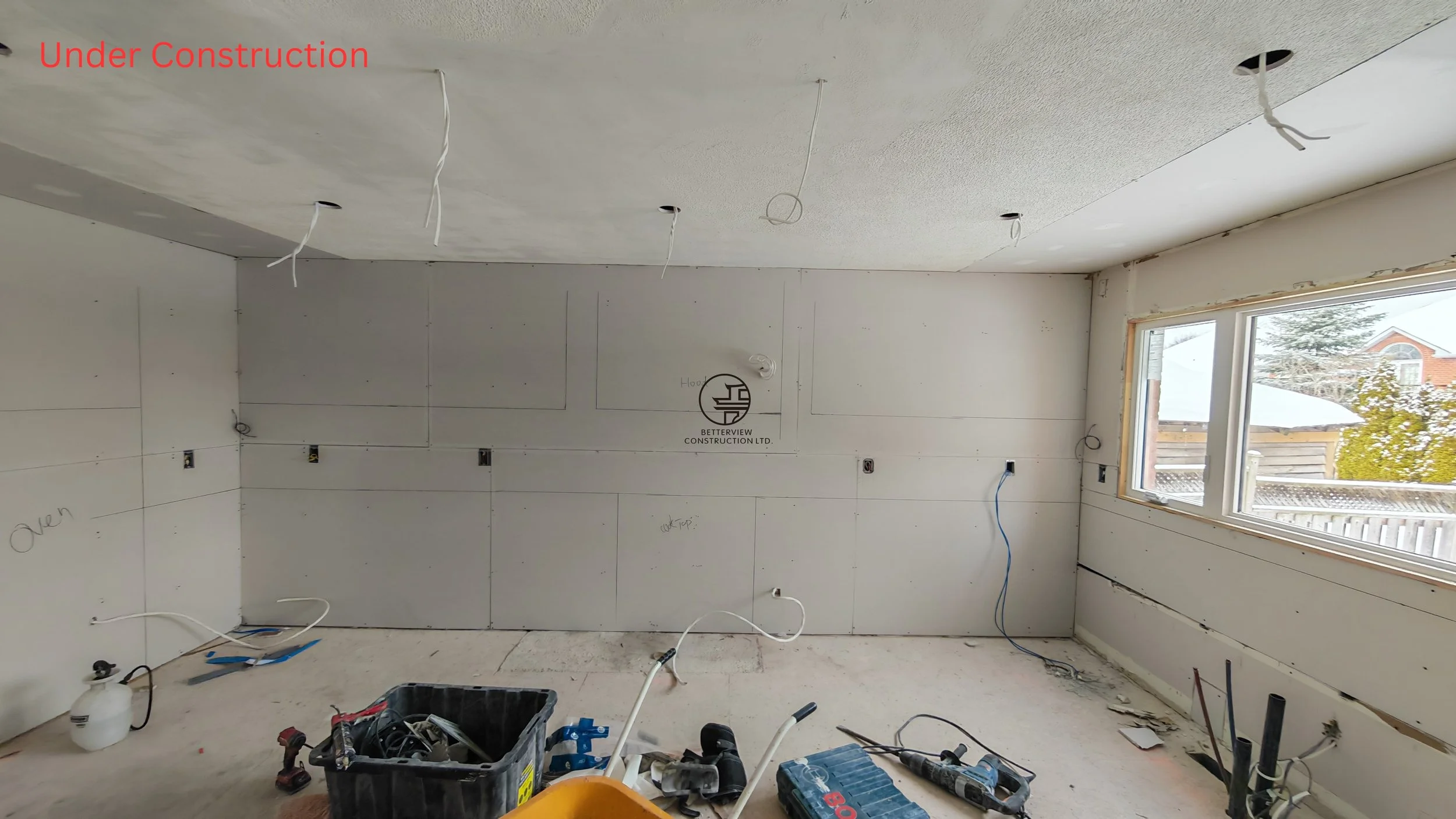 home renovation in progress with drywall installation electrical wiring exposed and construction tools in unfinished residential interior