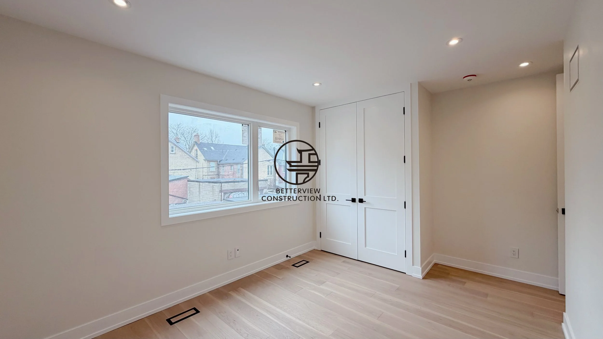 modern-bedroom-renovation-large-window-hardwood-flooring-built-in-closet-toronto.jpg.jpg