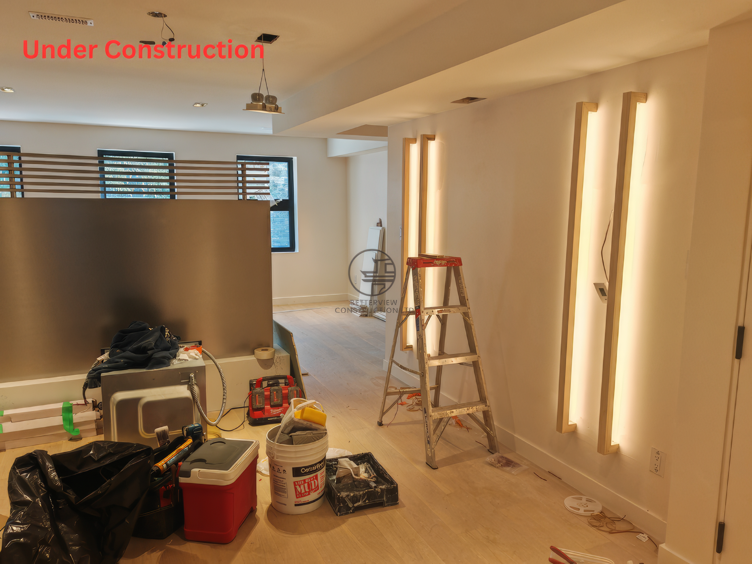 Feature wall lighting installation in a Toronto home renovation showing vertical light strips, open concept layout, and construction in progress
