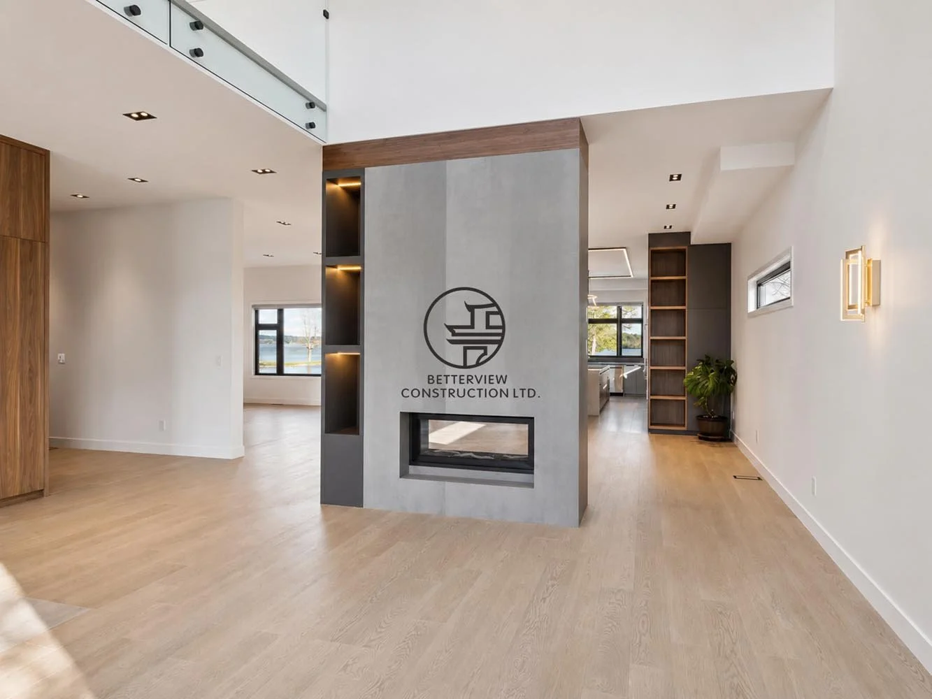 Modern interior with fireplace feature wall, open-concept layout, light wood flooring, built-in shelving, and clean minimalist design.